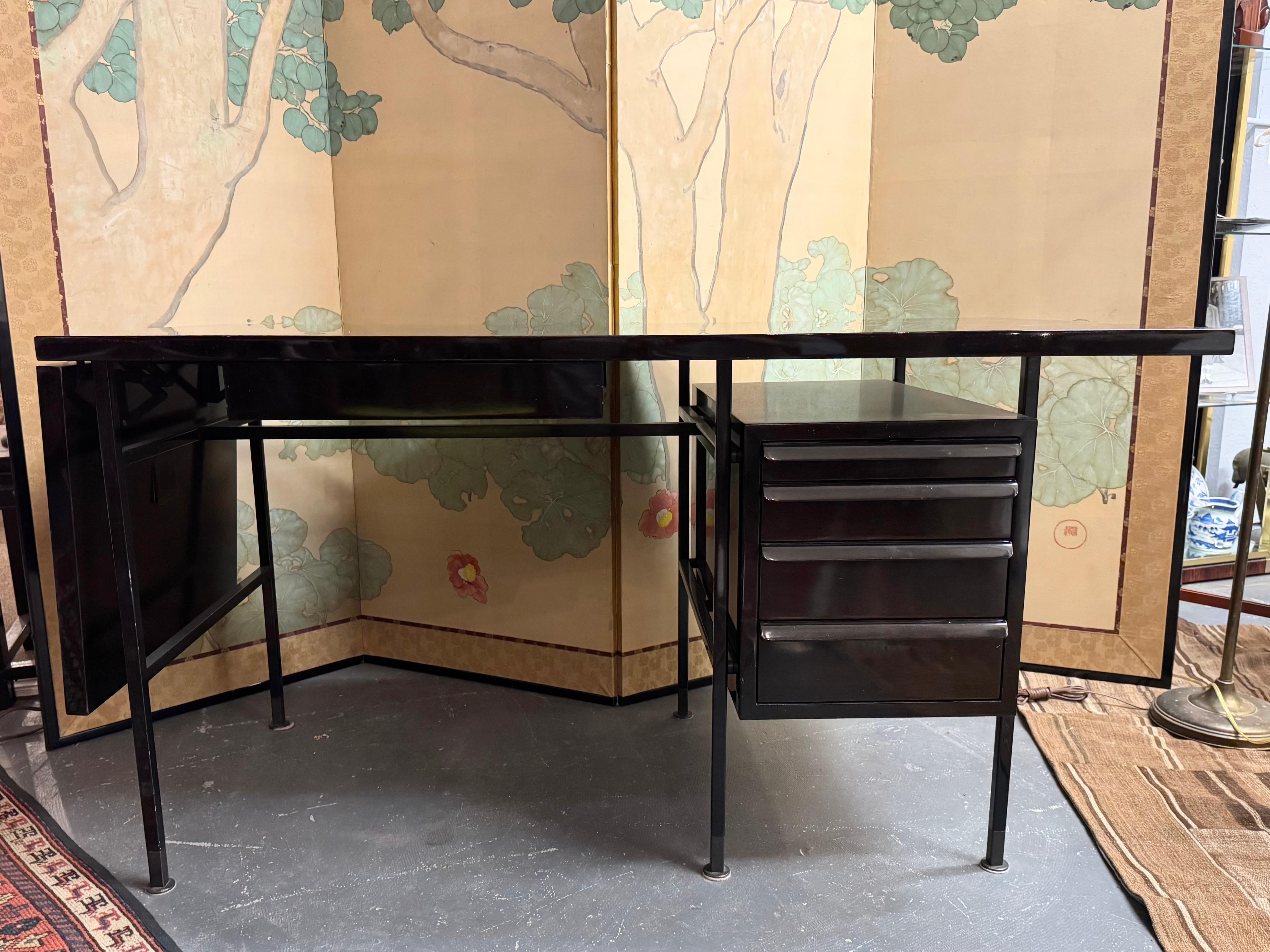 An exceptional and rare drop leaf desk by Edward Wormley for Dunbar in Tawi Walnut & Steel.

USA, circa 1950. 

Mid-Century Modern Dunbar Desk
Hardwood veneers
Berne, Indiana
Angular top with drop leaf and three drawers with lip pulls in rosewood