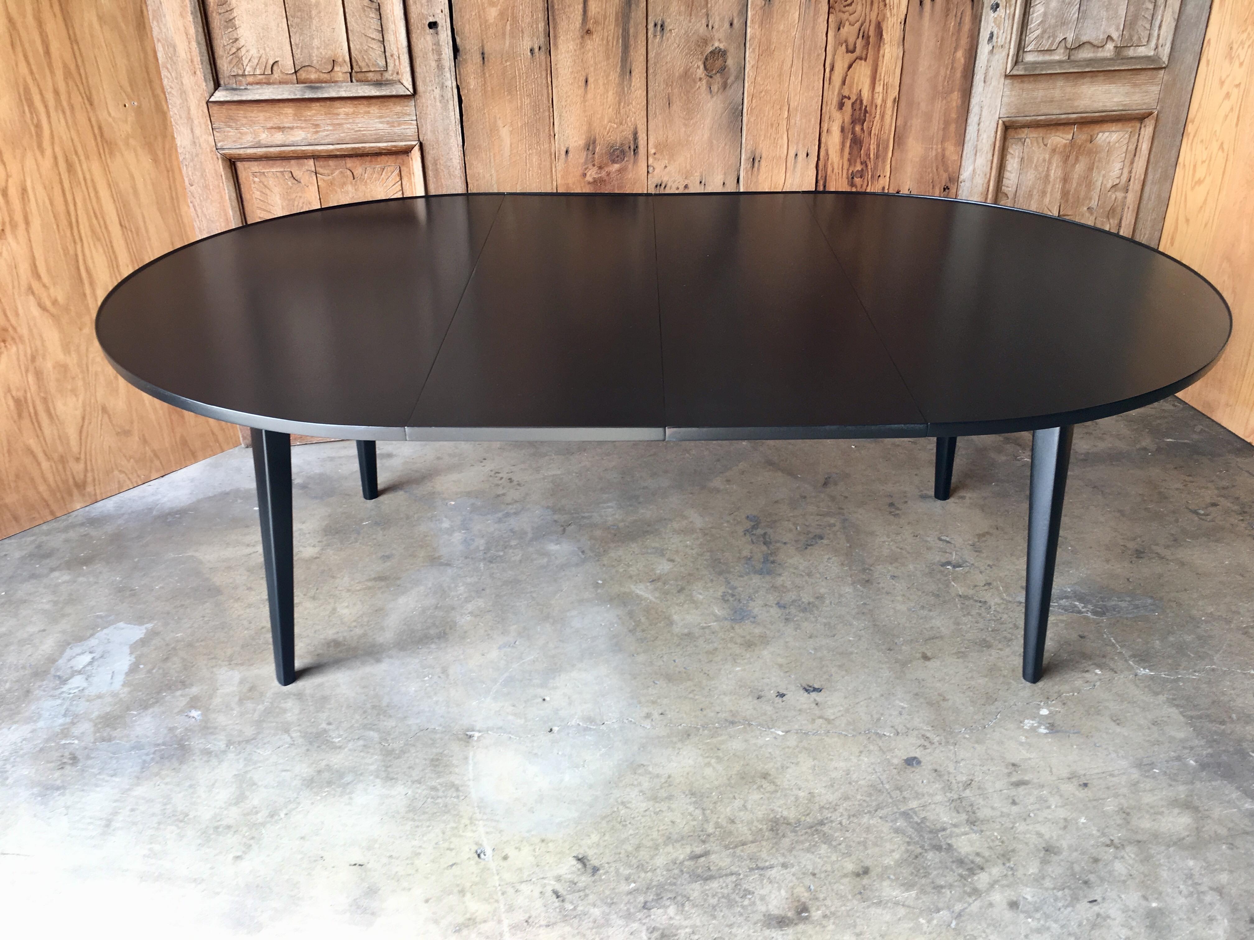 Round ebonized dining table made by Dunbar Furniture Company Designed by Edward Wormley
In it's smallest form the table is 54