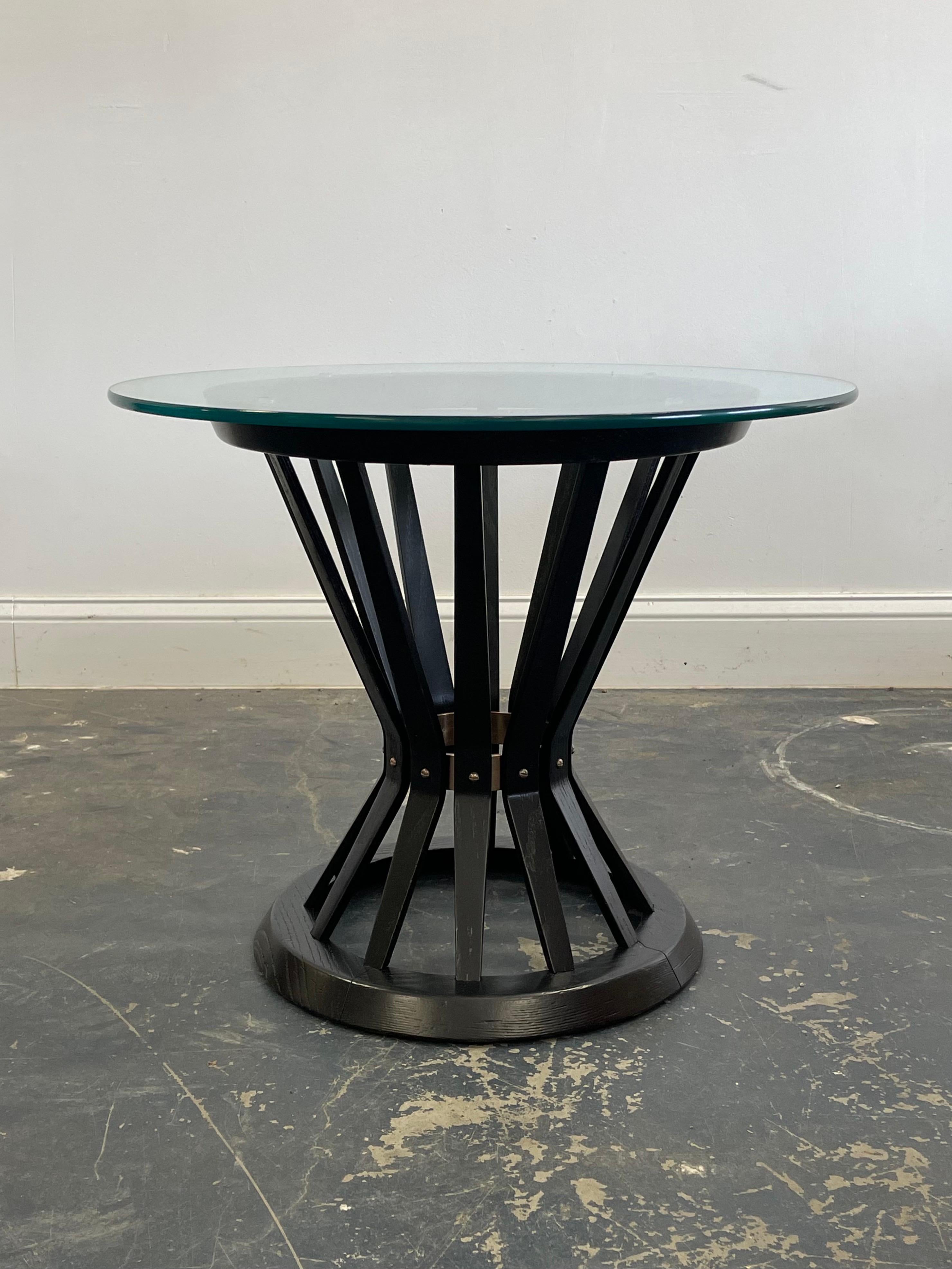 A classic Sheaf of Wheat Table Designed by Edward Wormley for Dunbar. TAble has been freshly ebonized. Brass ring and hardware gently cleaned. Replacement glass top is 3/8” thick

Would work well with other designers from the period such as T.H.