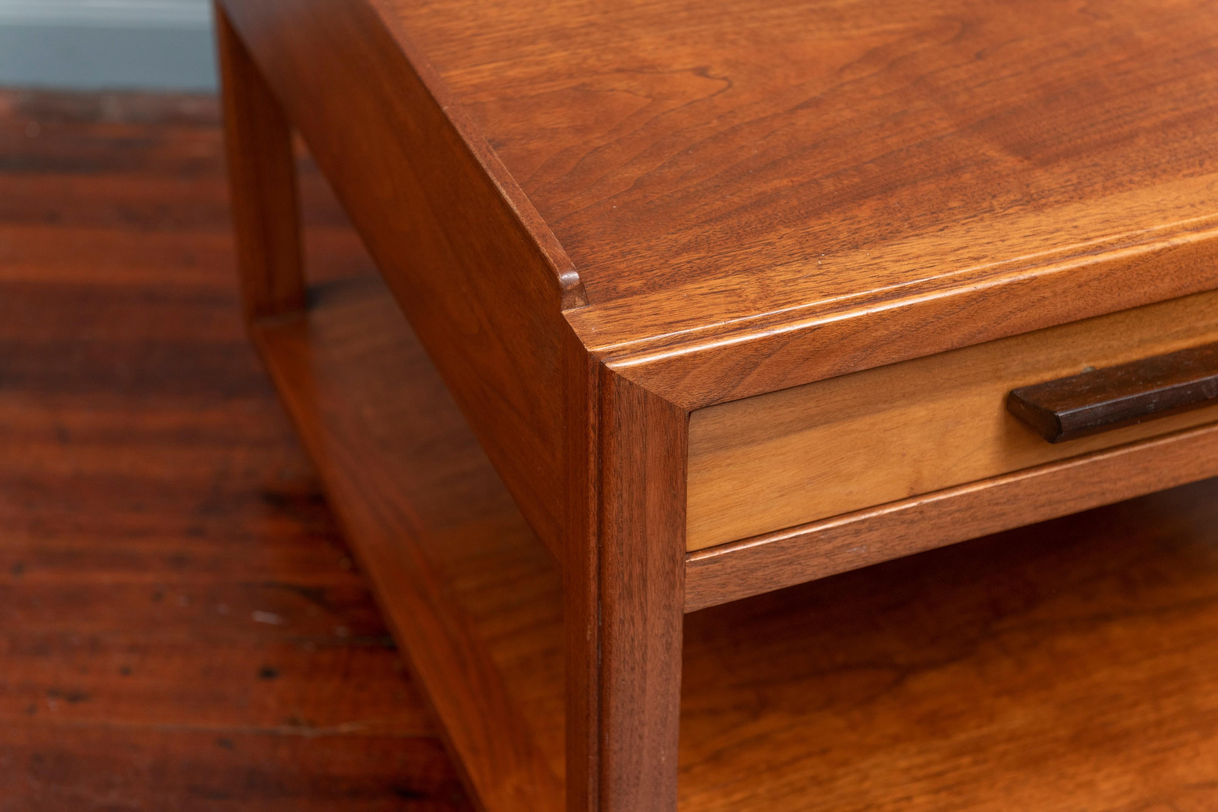 Edward Wormley for Dunbar large end table. Having a single drawer and gallery edge top on brass casters in mahogany, labeled.