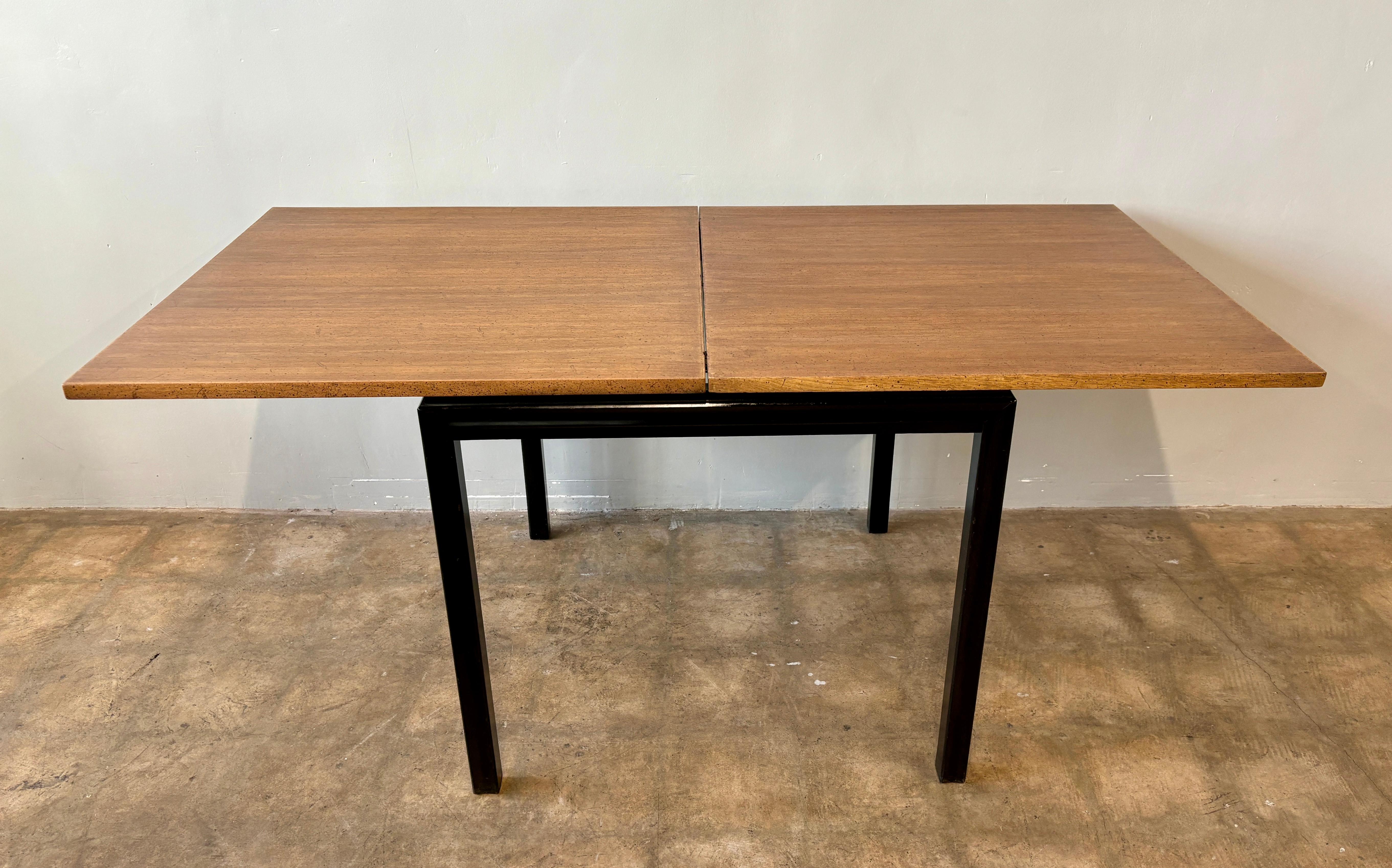 Edward Wormley for Dunbar expanding dining table.  Walnut veneer folding top on black lacquer base.   Rare table in good vintage condition. Top has been refinished.  
Some wear and tear.  Solid and functional. 

32” x 32” x 30” h
32” x 64” x 30” h