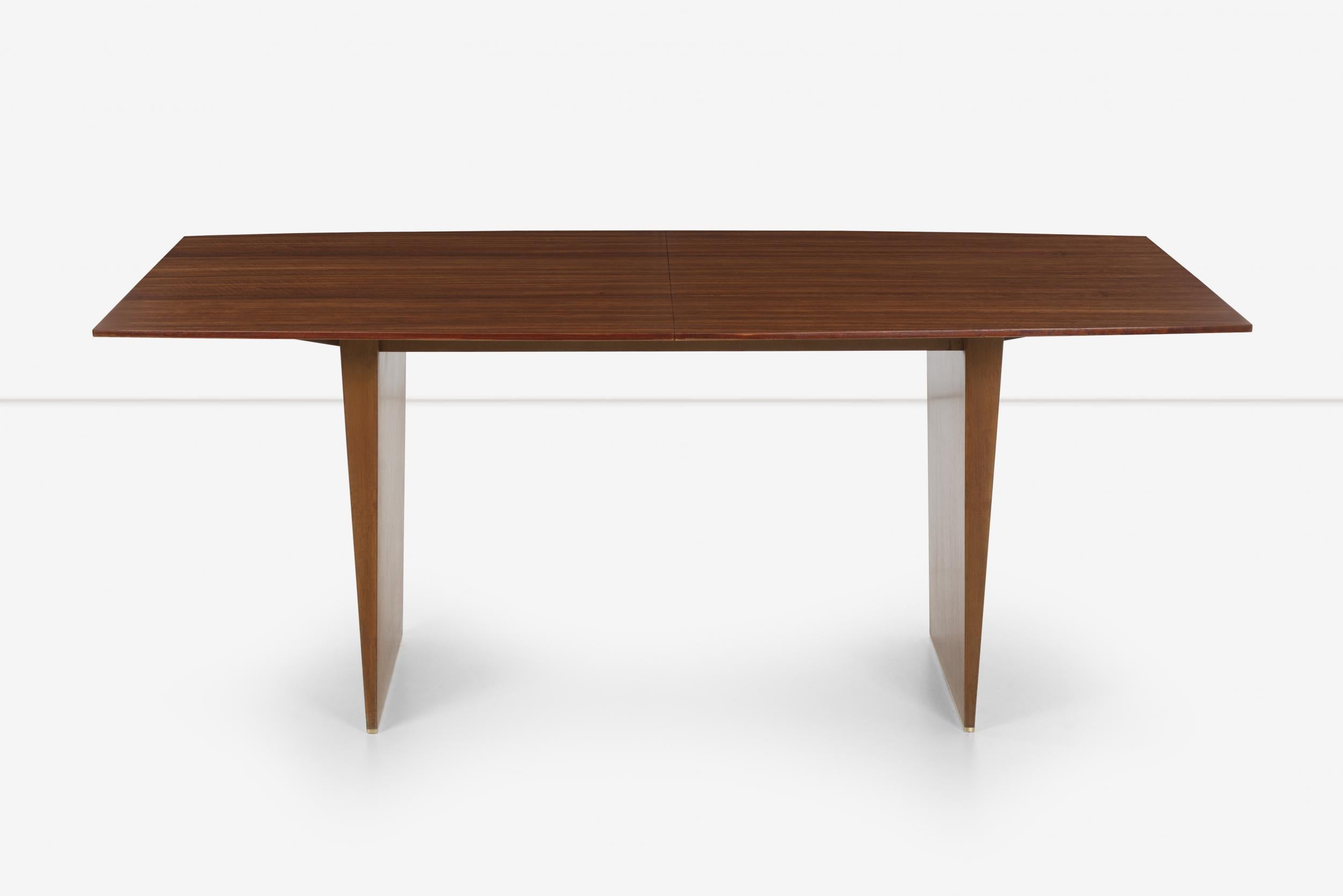 Edward Wormley for Dunbar extension dining table seats 6 to12, This special piece custom for the Los Angeles Showroom (tag underside).
Etimoe African Rosewood top with cross grain extensions, Mahogany base with brass glide runners.

Measures: