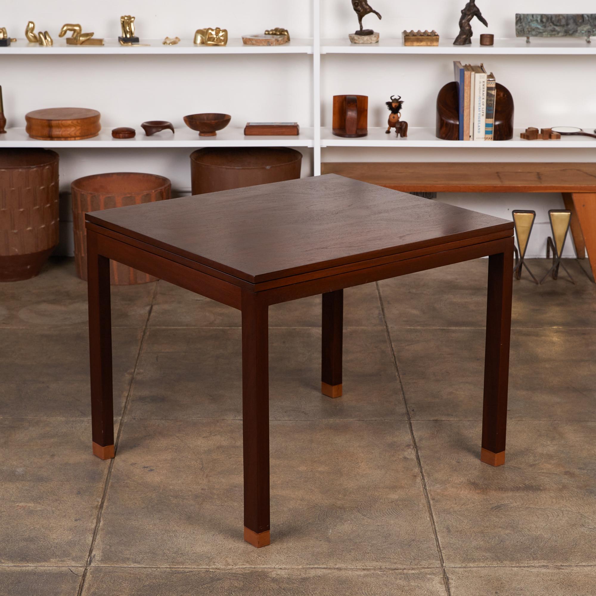 Edward Wormley for Dunbar flip-top table, USA, c.1960s. This square Parsons table features a flip top that allows it to serve as a cafe/dining table or game table. The dark stained mahogany legs are accented by leather wrapped tips. The table also