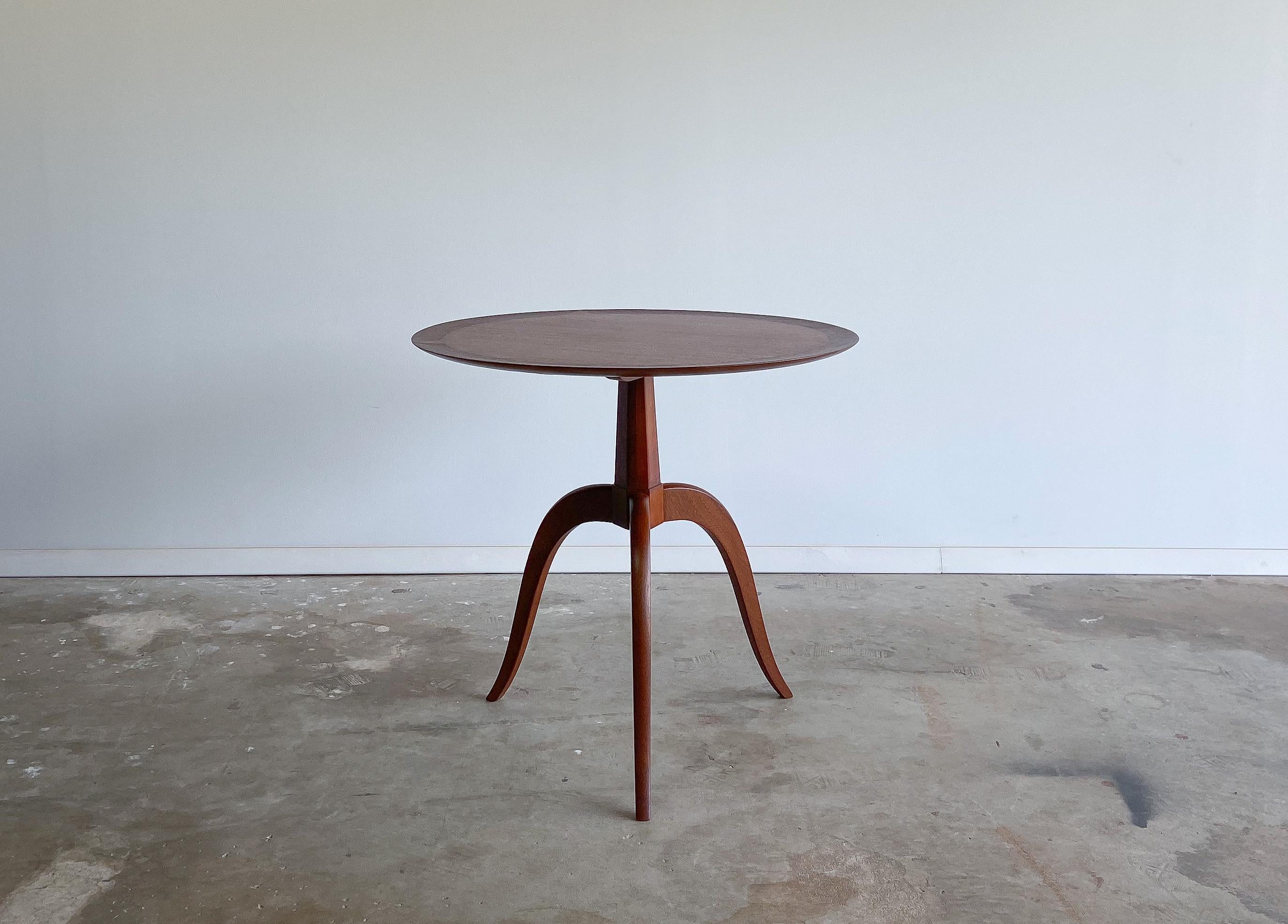 An elegant side or end table designed by Edward Wormley for Dunbar, circa 1950s.

Featuring Dunbar's unmatched quality; this table has a beautiful surface made from ribbon mahogany with a contrasting solid walnut outer ring.

The base/legs are