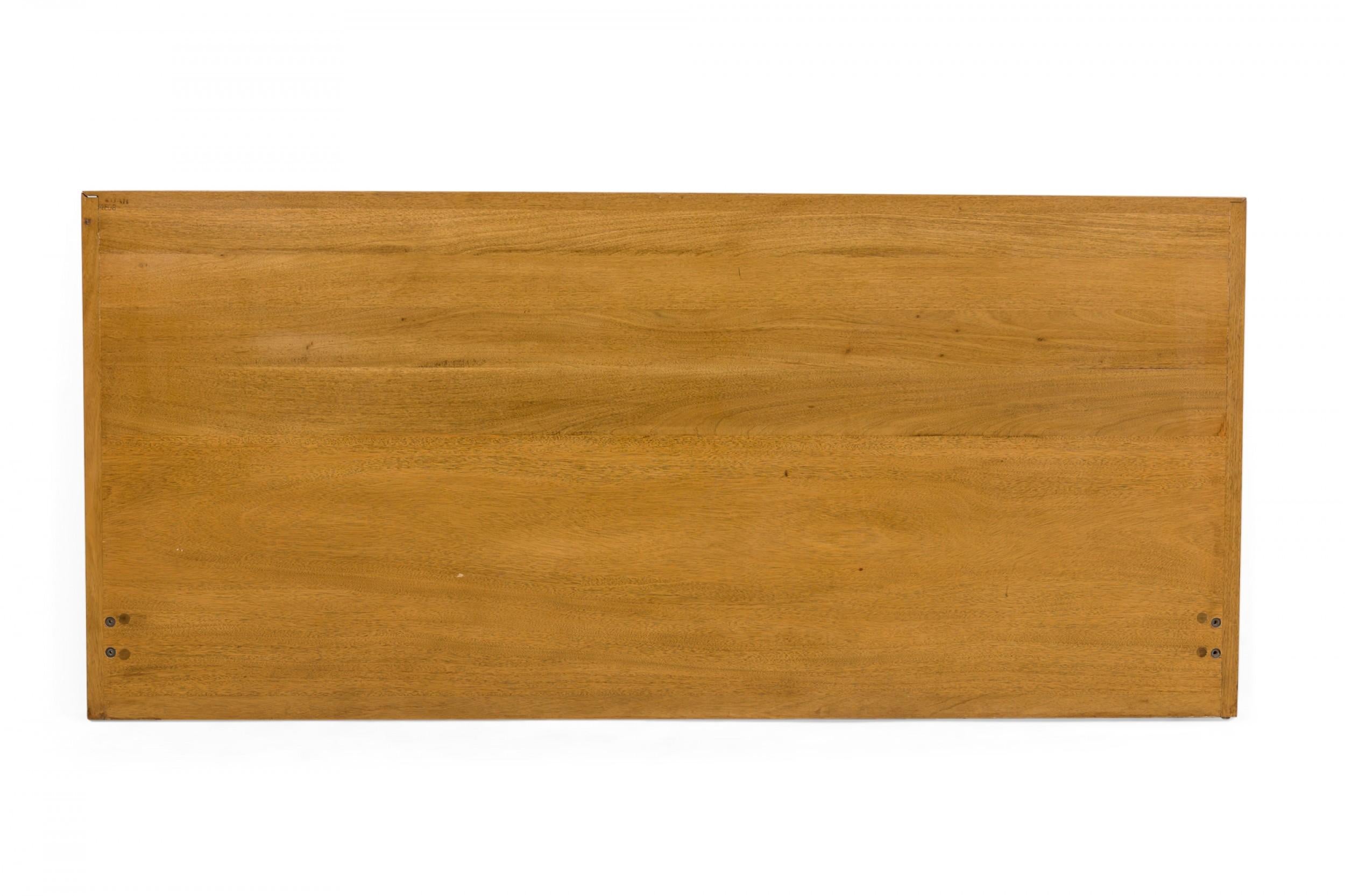 Cabecero de cama king-size americano de mediados de siglo, con singulares paneles de lamas horizontales de caoba clara que se extienden a lo ancho de la cama. (EDWARD WORMLEY PARA DUNBAR FURNITURE COMPANY)

Desgaste hasta el acabado