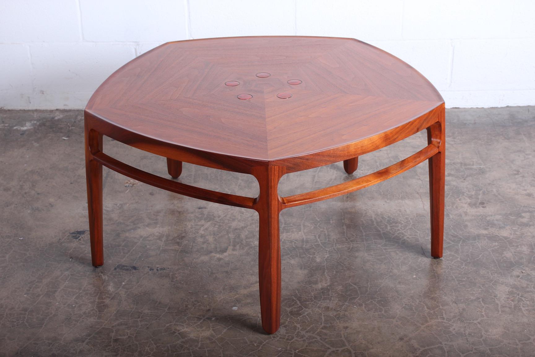 A walnut Janus coffee table with inset ceramic tiles by the Natzlers. Designed by Edward Wormley for Dunbar.