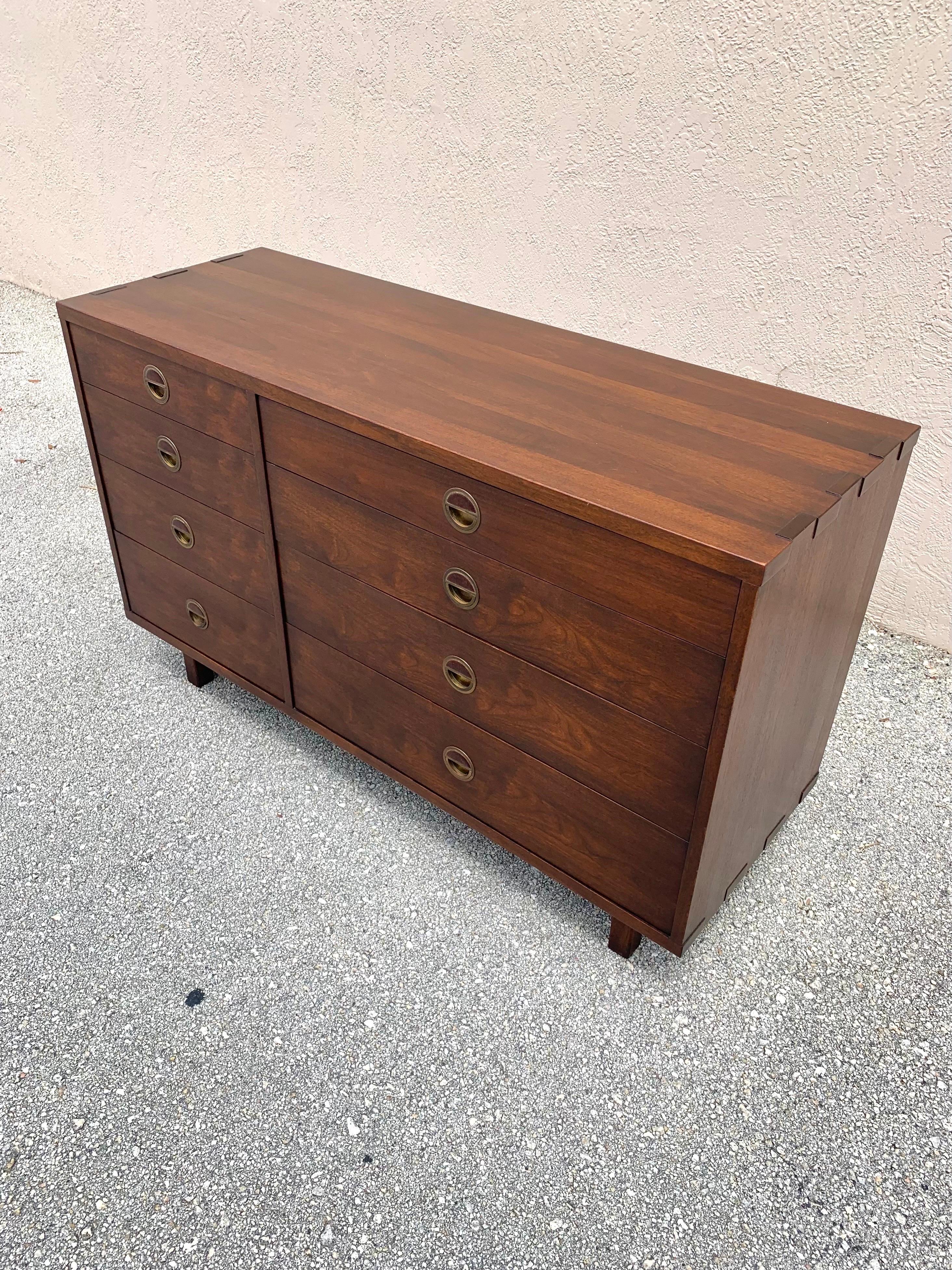 Chest of drawers designed by Edward Wormley for his Janus Collection for Dunbar Furniture. Made of walnut and expertly crafted. Beautiful joinery details on the corners of the cabinets. 8 drawers in total. Solid brass drawer pulls with Natzler for