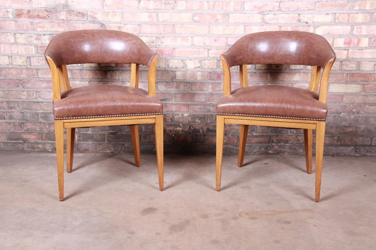 An exceptional pair of Mid-Century Modern club chairs or dining armchairs

By Edward Wormley for Dunbar Furniture

USA, 1950s

Solid mahogany frames, with original brown leather seats and curved seat backs.

Measures: 22