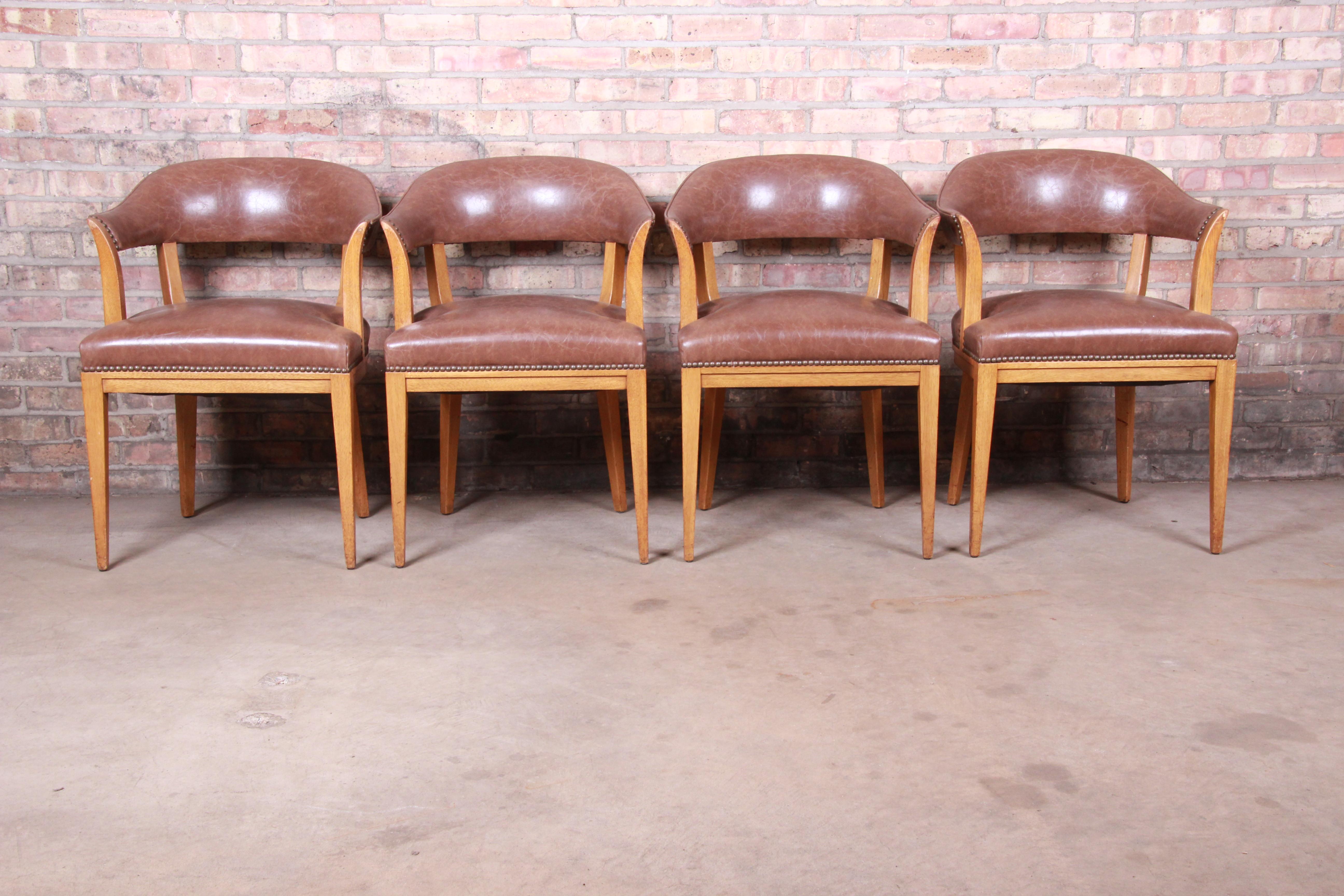 An exceptional pair of Mid-Century Modern club chairs or dining armchairs

By Edward Wormley for Dunbar Furniture

USA, 1950s

Solid mahogany frames, with original brown leather seats and curved seat backs.

Measures: 22