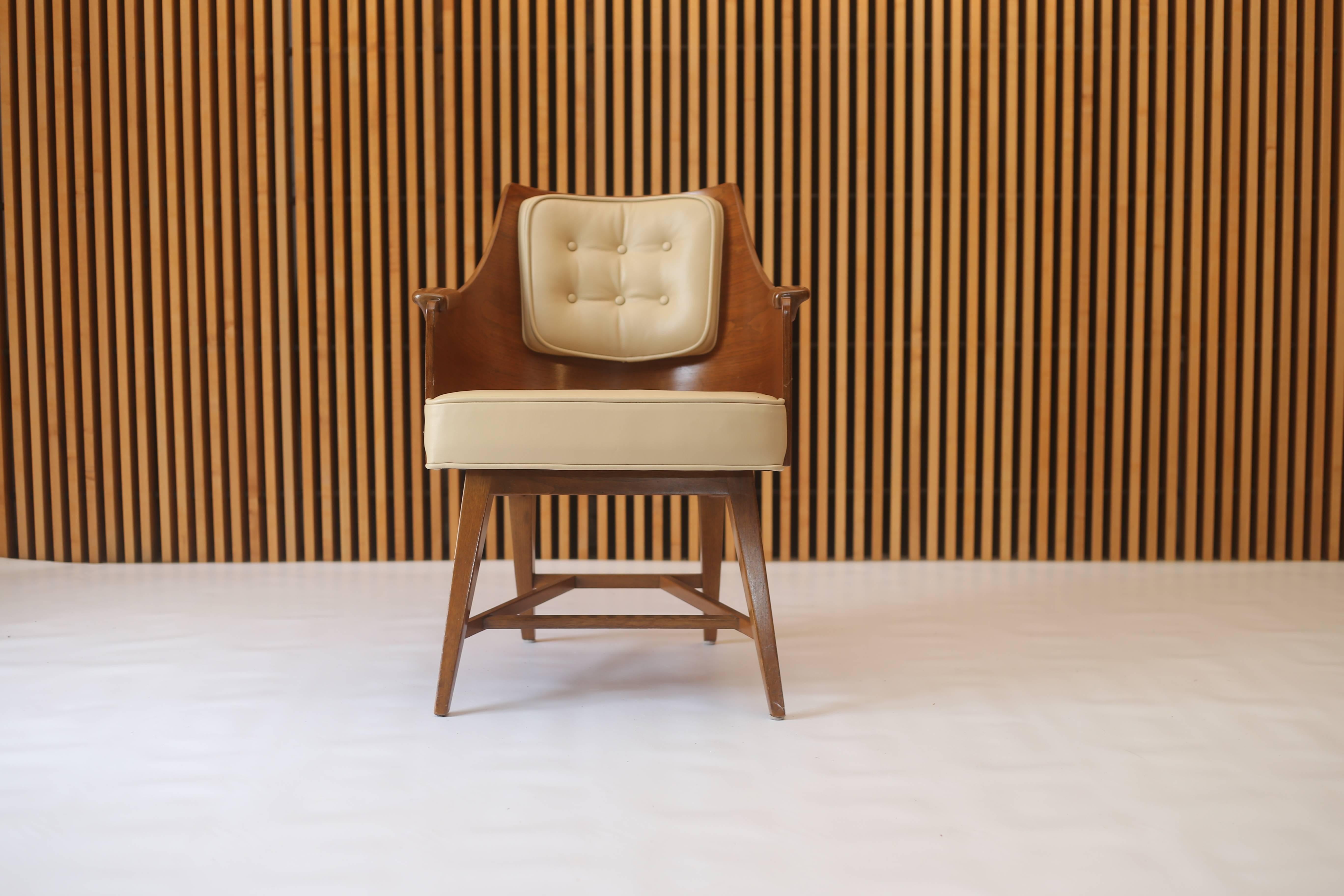 This model no. 5646 chair designed by Edward Wormley for Dunbar furniture consists of a walnut barrel back with solid paddle arms and was recently upholstered in a buttery beige edelman top grain leather. 

Dimensions:
23
