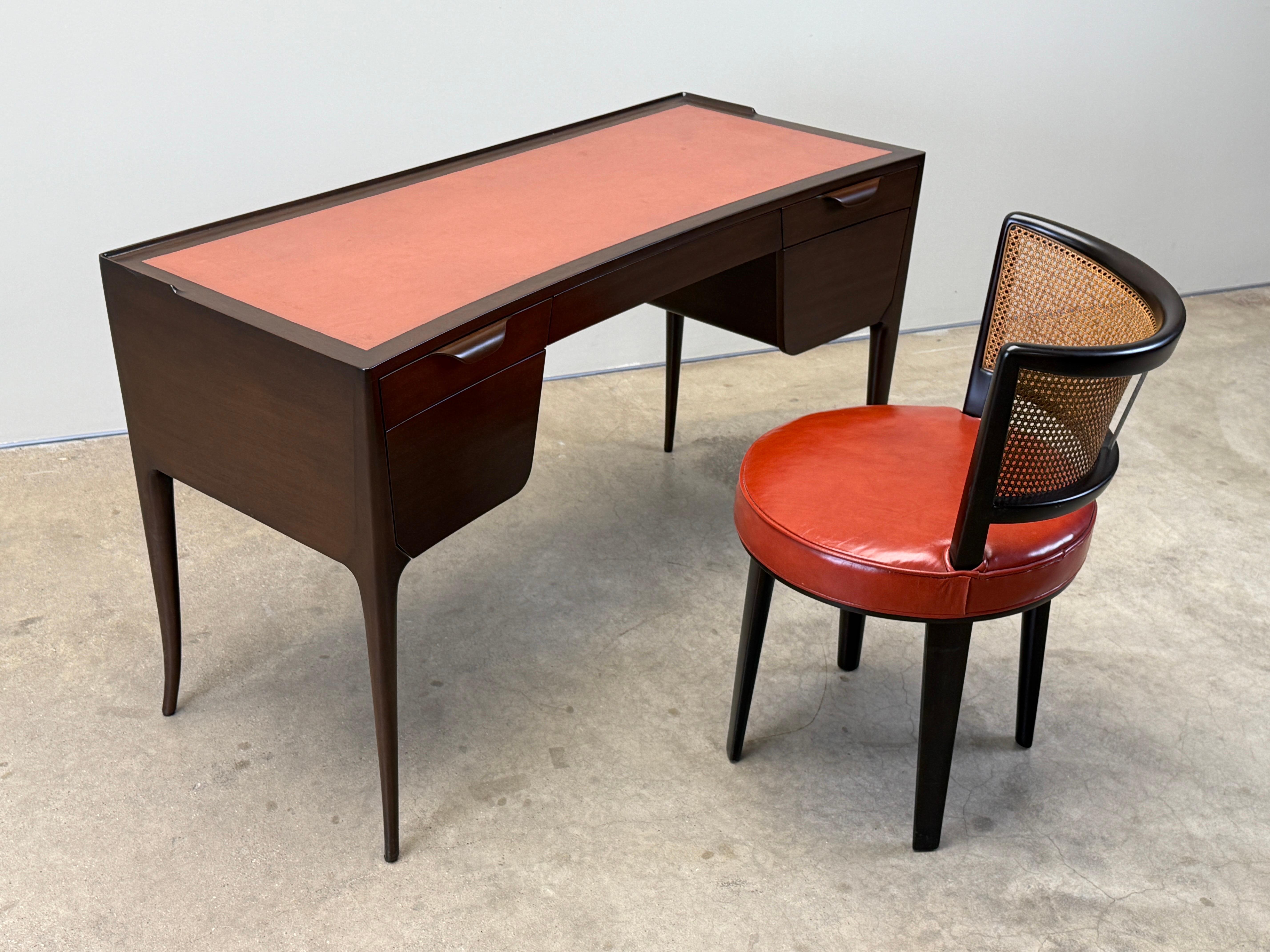 An elegant and early design by Edward Wormley for Dunbar. Desk model 4725 in mahogany with original salmon colored leather. 