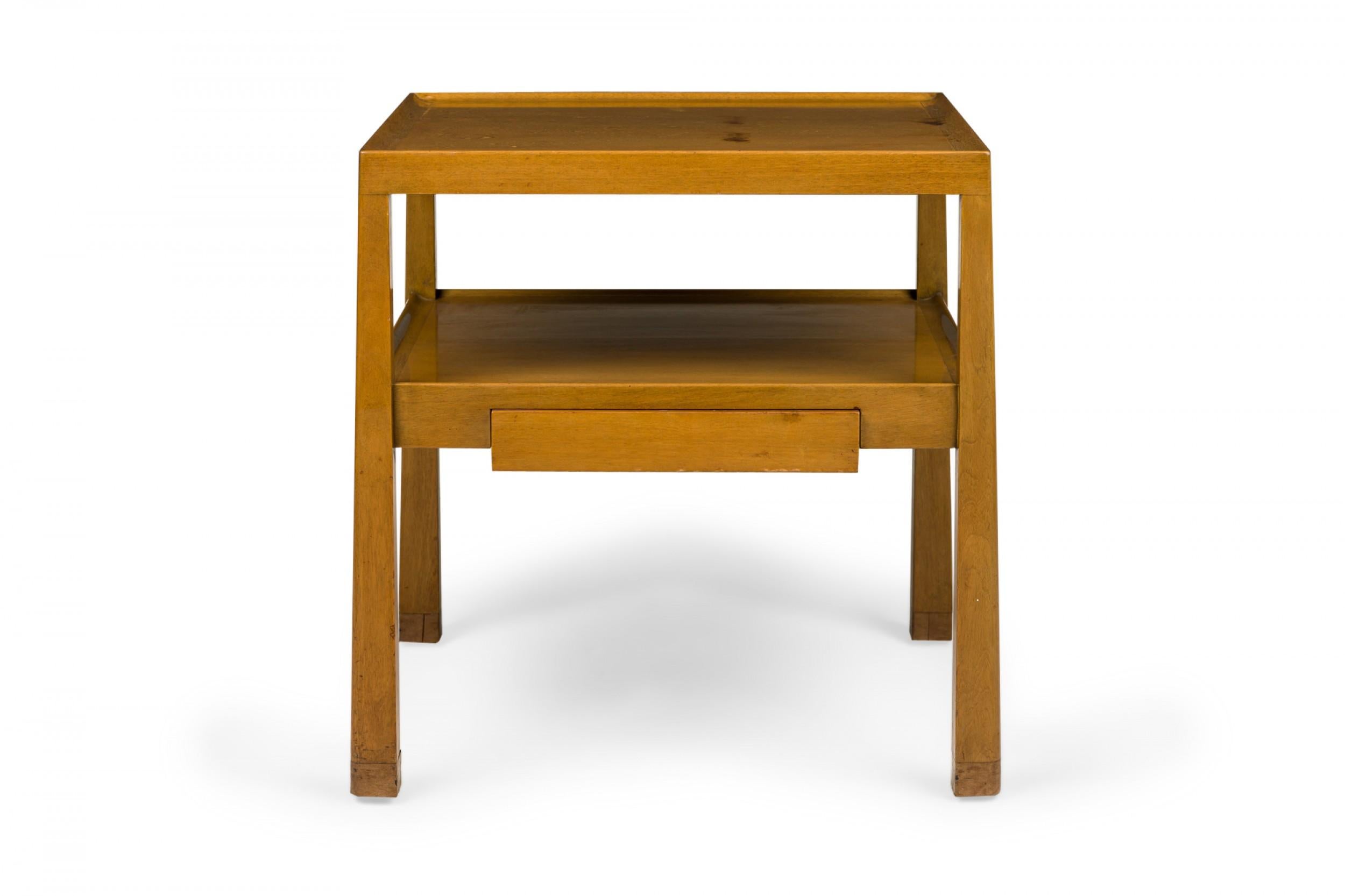 American Mid-Century two-tier end / side table with a square top with a shallow gallery above a lower shelf containing a single drawer supported by two reverse tapered legs. (EDWARD WORMLEY FOR DUNBAR FURNITURE COMPANY)(Similar table: DUF0759)
