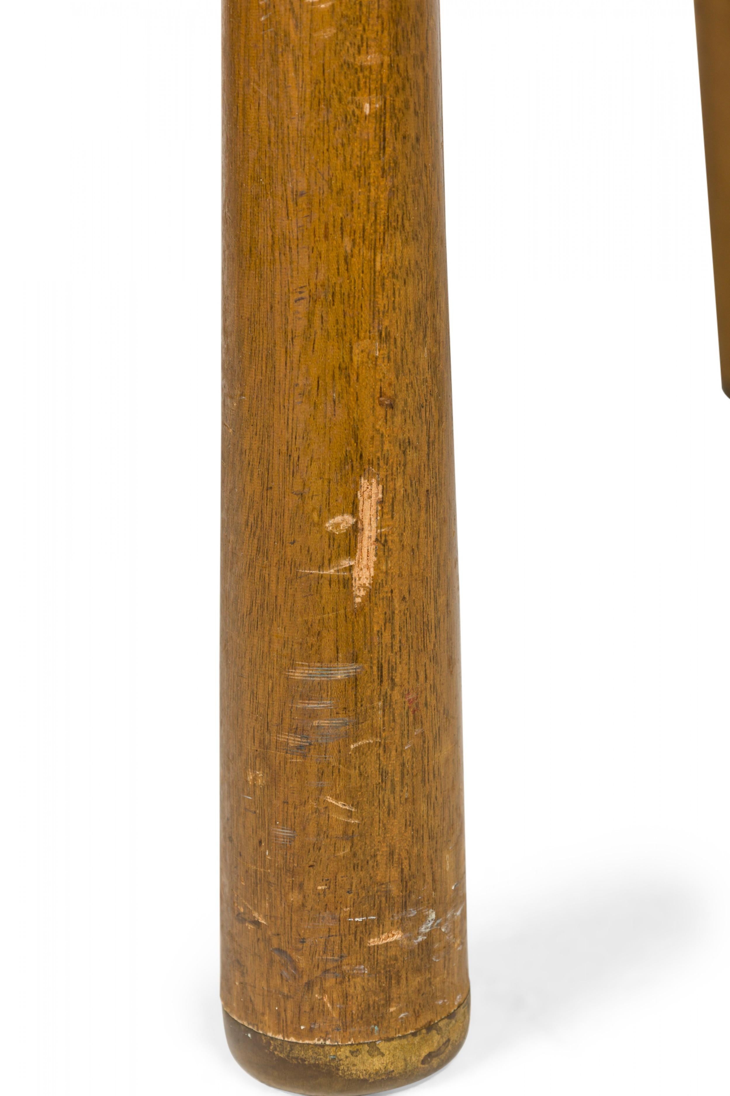 American Mid-Century stepped end / side table with an oblong profile and smaller demilune upper shelf connected to the table top by two dowel supports, resting on three reverse tapered dowel legs. (EDWARD WORMLEY FOR DUNBAR FURNITURE
