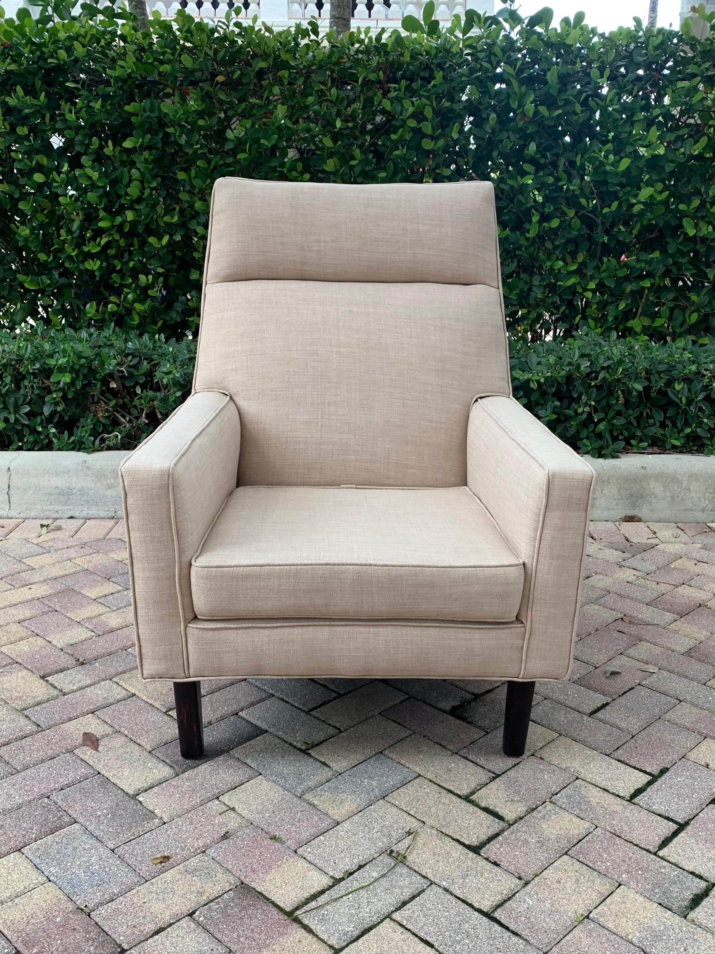 Tall back lounge chair designed by Edward Wormley for Dunbar furniture. Beautiful crisp lines frame the chair with grace and style. Edward Wormley’s designs are still often mimicked for high end designer furniture today. Made by one of the best
