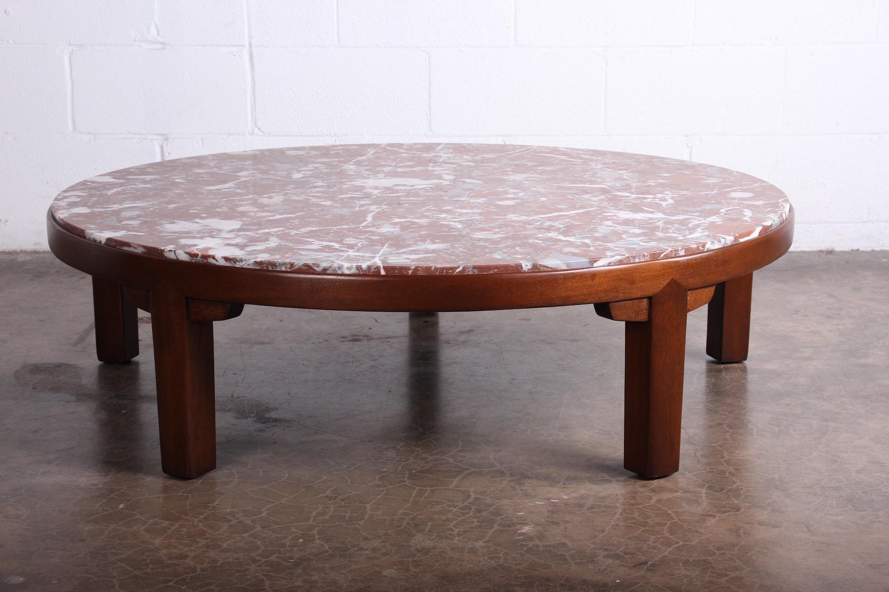 A mahogany coffee table with figurative honed marble top. Designed by Edward Wormley for Dunbar.