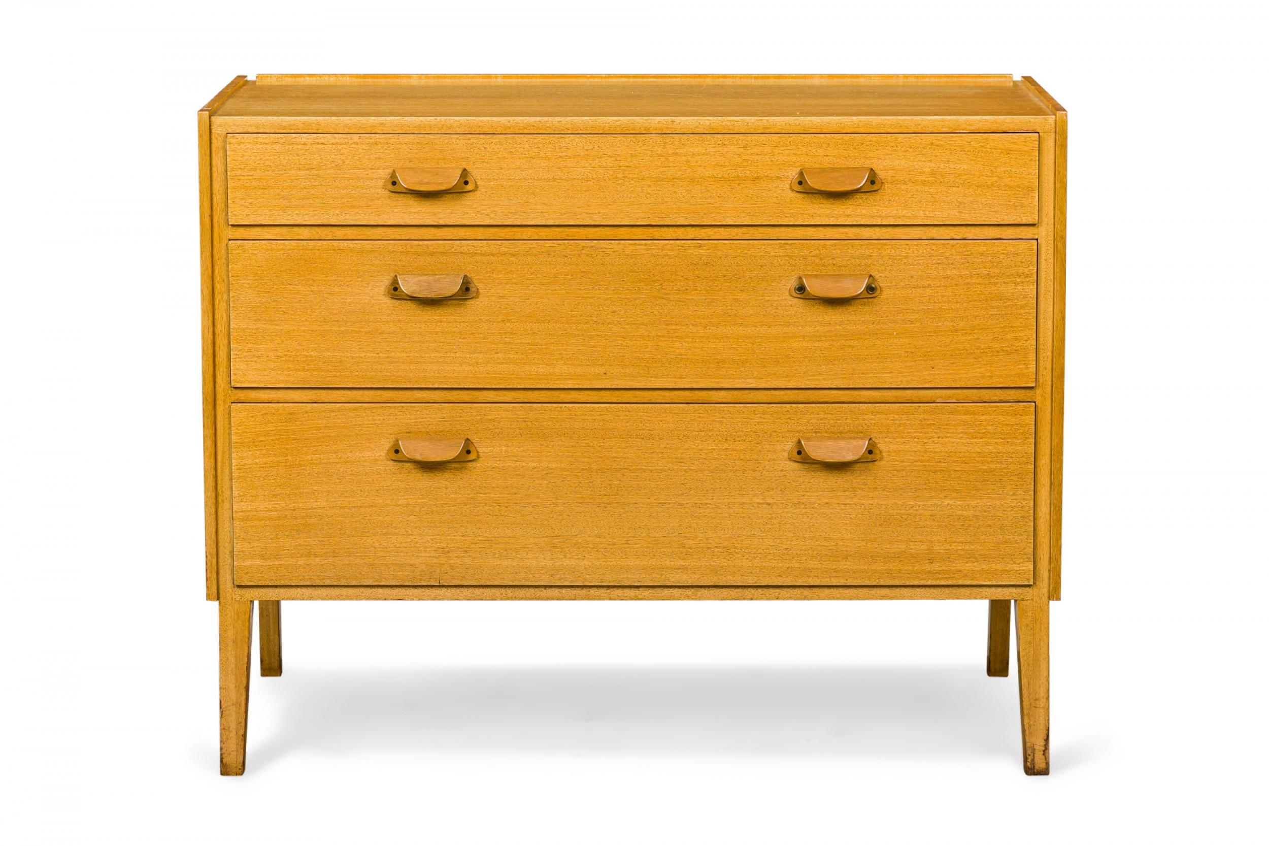 American Mid-Century maple slant front chest with three drawers with semi-circular wooden drawer pulls, resting on four tapered square wooden legs. (EDWARD J WORMLEY FOR DUNBAR FURNITURE COMPANY).
