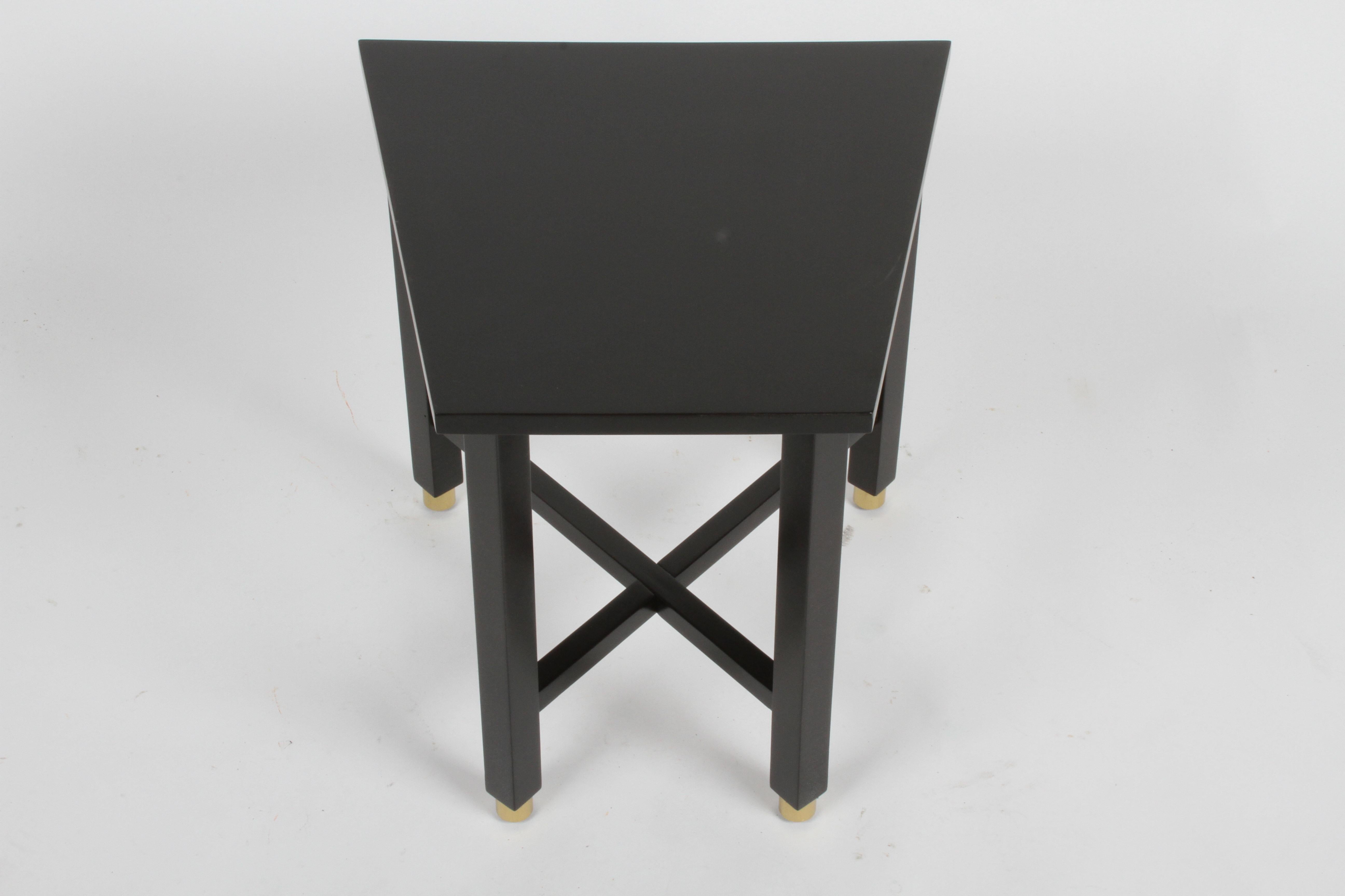 Newly refinished Edward Wormley for Dunbar Mid-Century Modern mahogany wedge or Trapezoidal end, drinks or side table in dark ebony with cross stretchers on round brass sabots. Marked with 