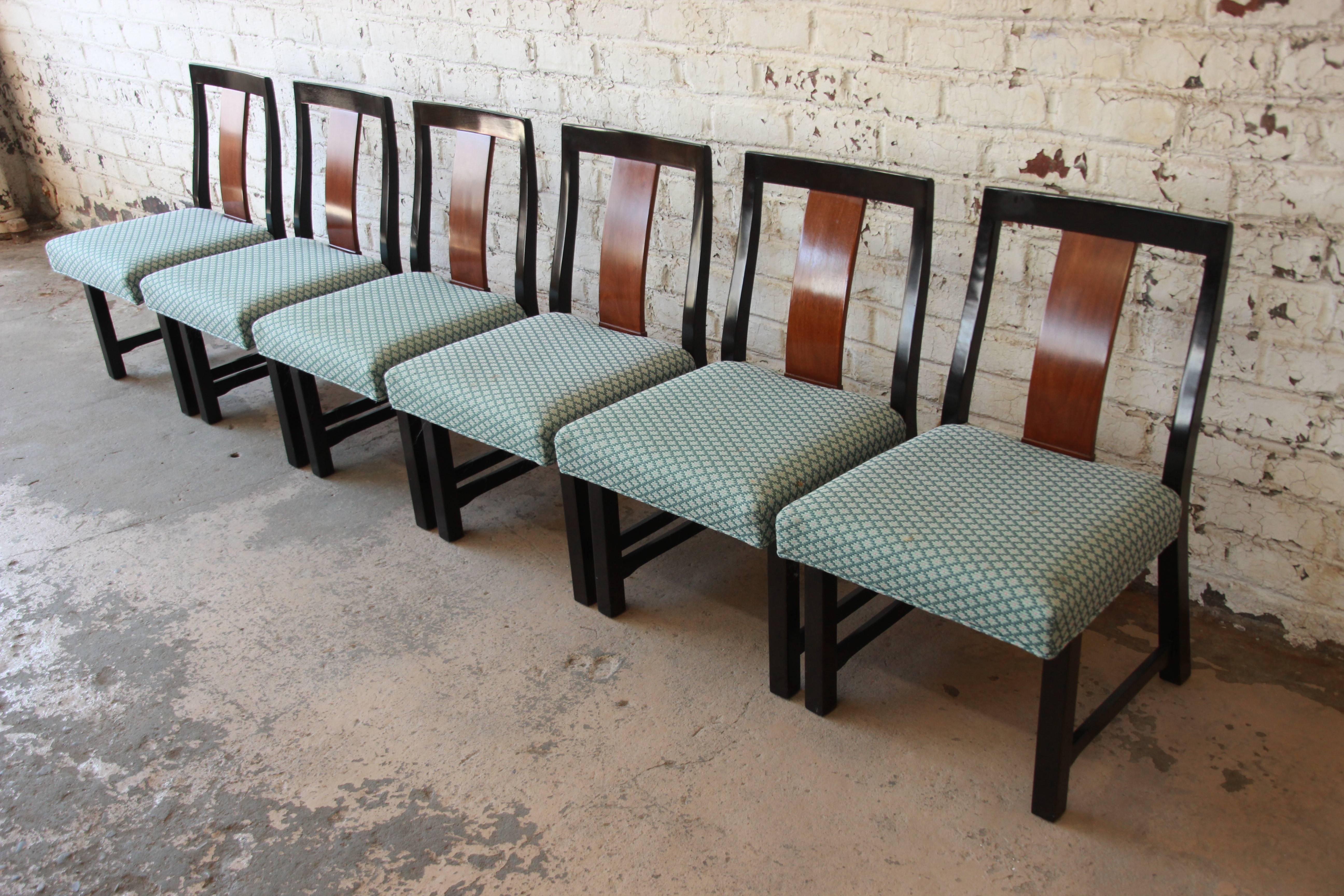 An outstanding set of six Mid-Century Modern dining chairs designed by Edward Wormley for Dunbar Furniture. The chairs feature solid walnut frames and slightly curved backrests for comfort. The light blue upholstery is original and in good