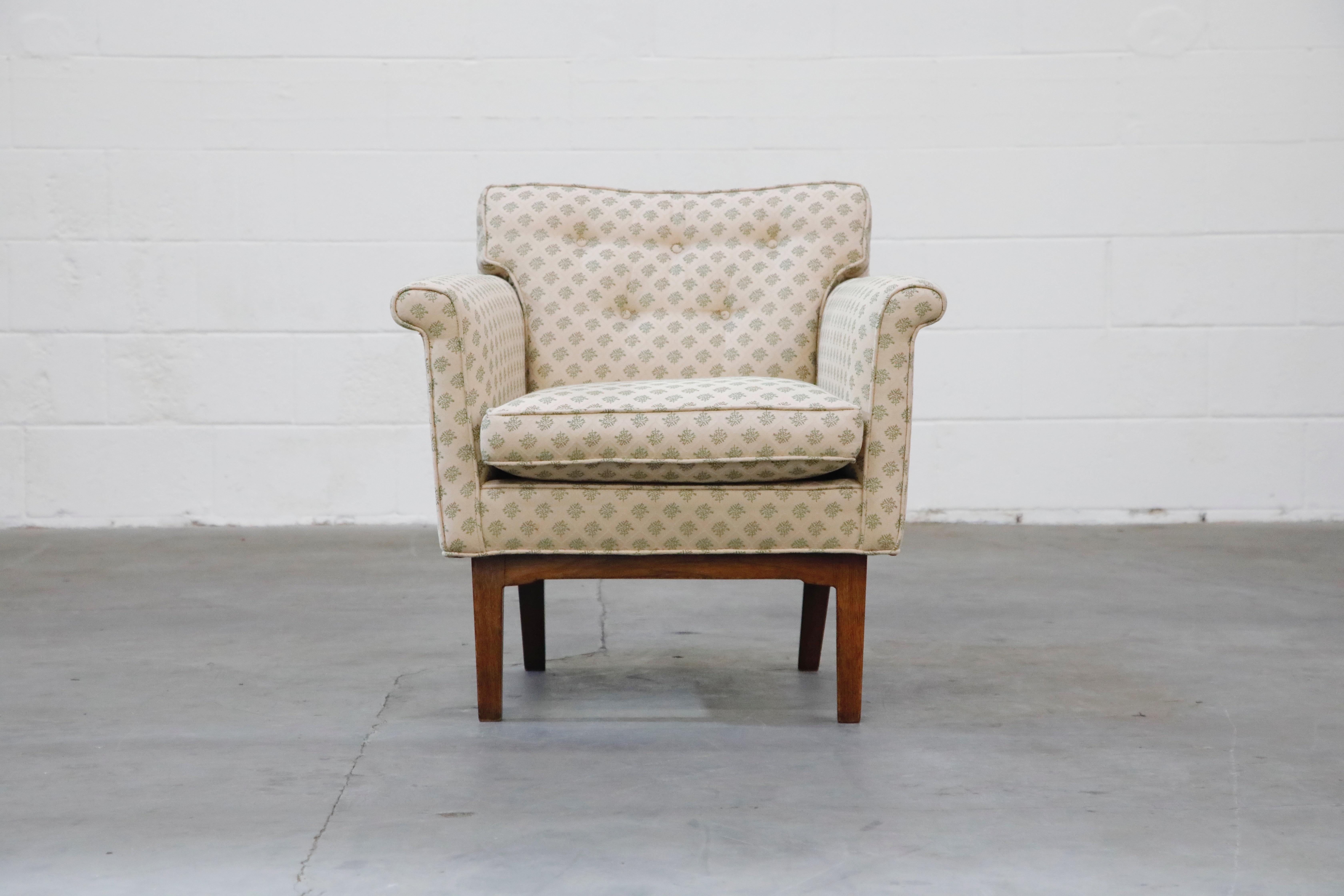 Elegant model 5706 chair by Edward Wormley for Dunbar. This lounge armchair features a simplistic design with rolled arms, tufted seat back, loose seat and back cushions, on a sculpted walnut base. This stylish armchair has been reupholstered in