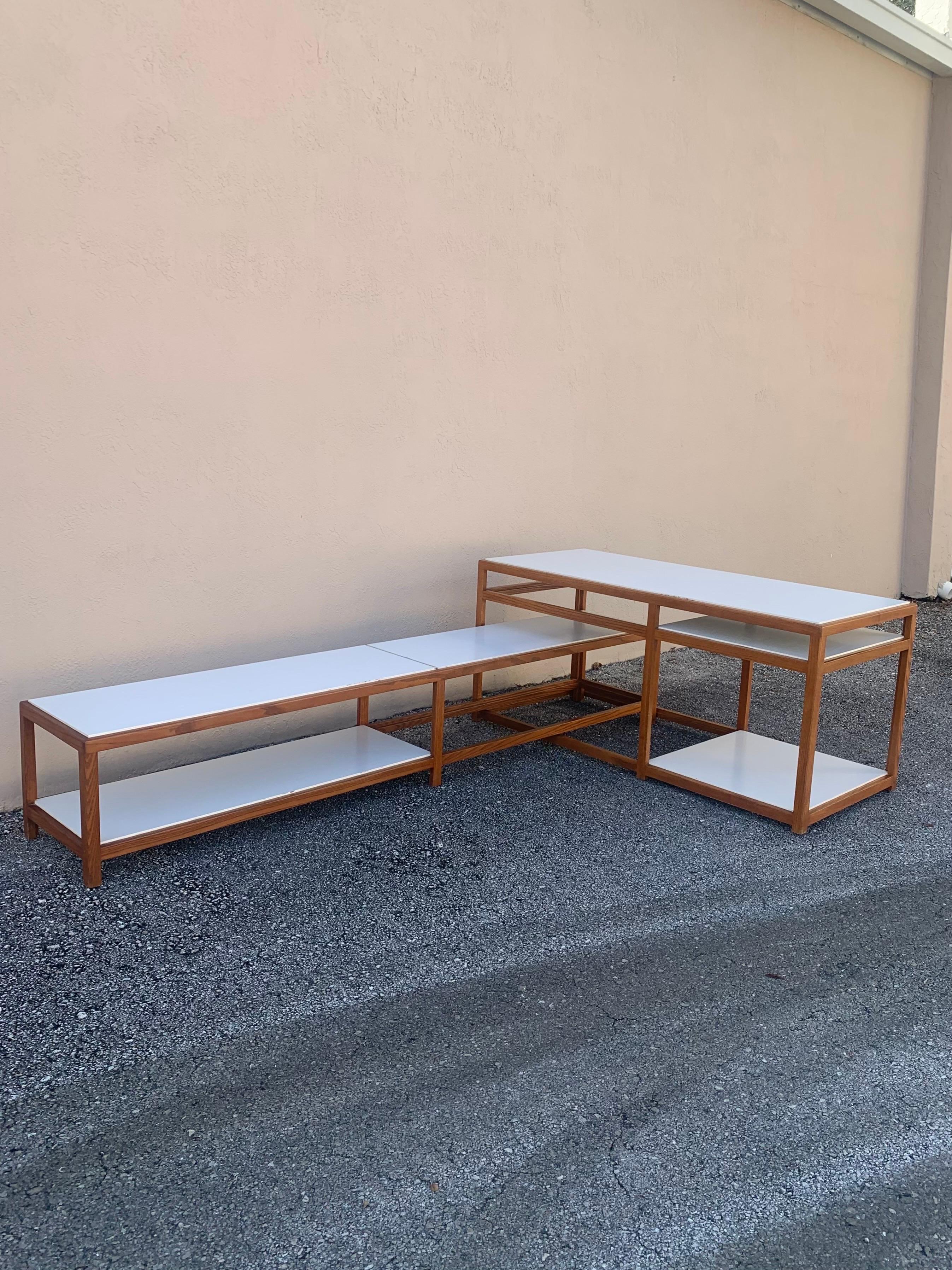 Beautiful set of tables designed by Edward Wormley for Dunbar. Architectural and Mid Century Modern in design. Tables have a simple elegant design. Both tables are marked. One long short console table and one taller table. Tables are modular in