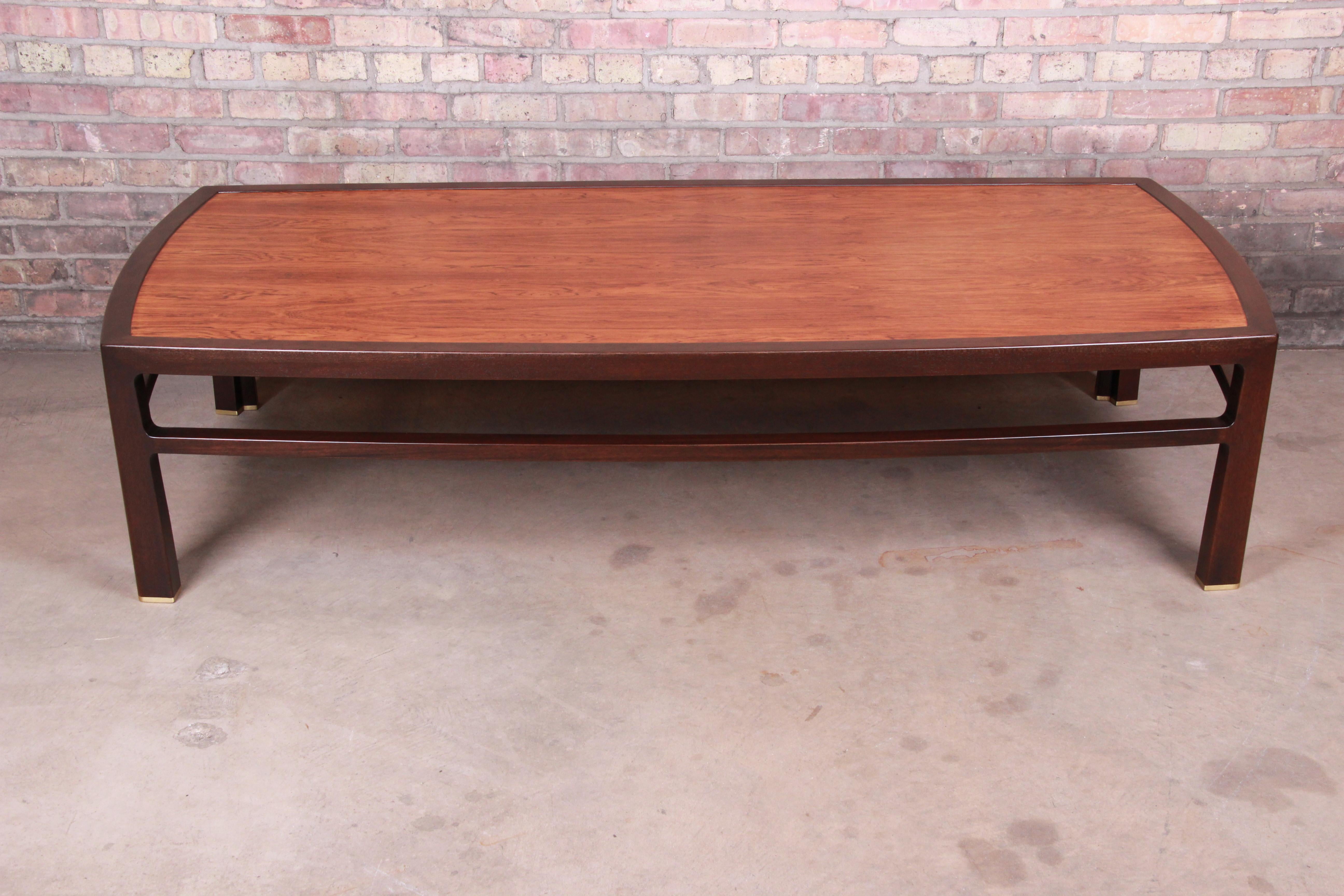 An exceptional Mid-Century Modern monumental coffee table

By Edward Wormley for Dunbar Furniture

USA, 1950s

Bookmatched rosewood top, with walnut trim and legs and brass-capped feet.

Measures: 72