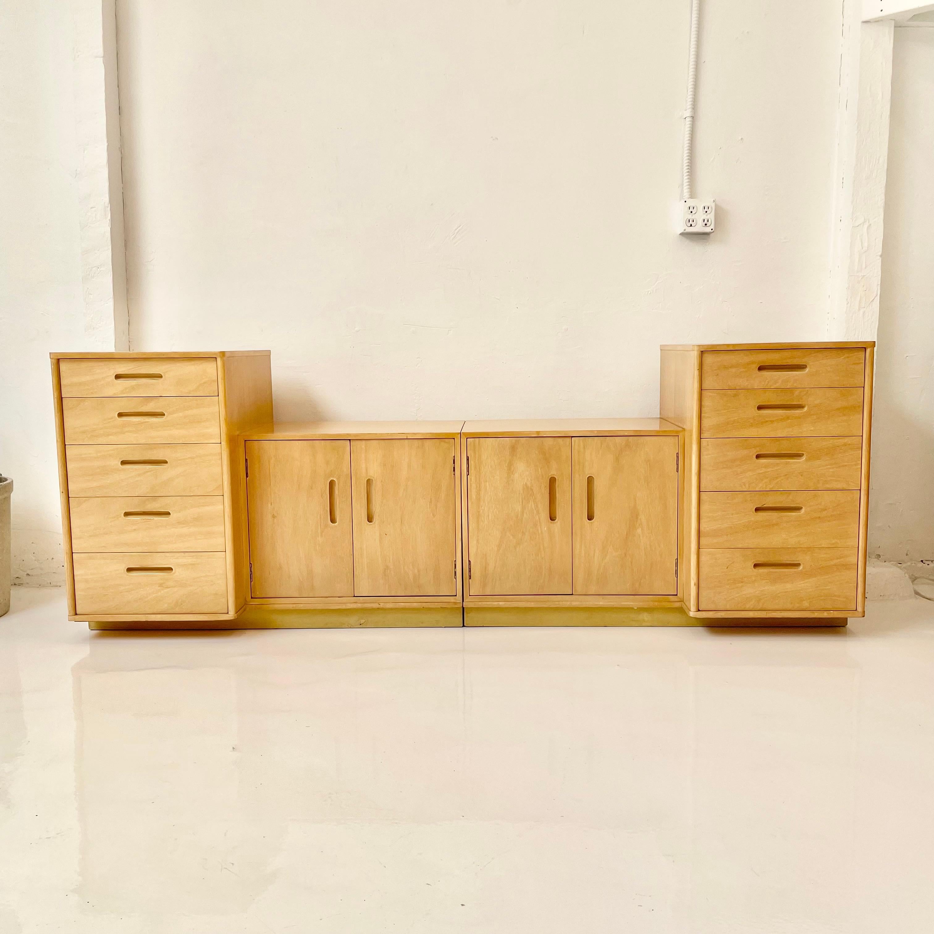 Early minimalist nightstands designed by Edward Wormley for Dunbar. Beautiful bleached mahogany cases with inset matching hardware and leather wrapped bases. Very functional set and perfect scale. Great as nightstands, cabinets or placed together