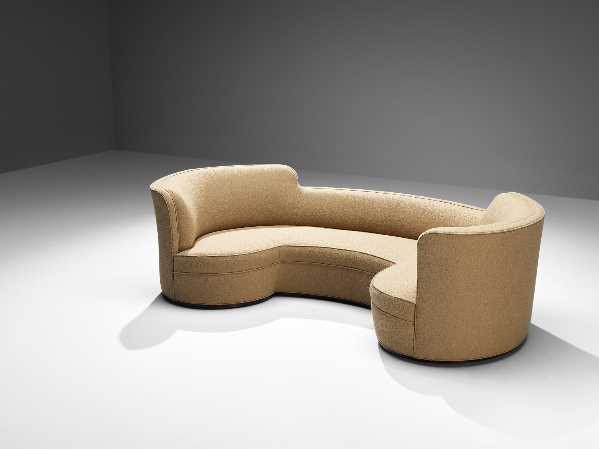 Edward Wormley for Dunbar, 'Oasis' sofa, model '5200', reupholstered in camel wool, mahogany, United States, design 1952 

The 'Oasis' sofa is designed by Edward Wormley for Dunbar. The construction is defined by a crescent shape with round edges