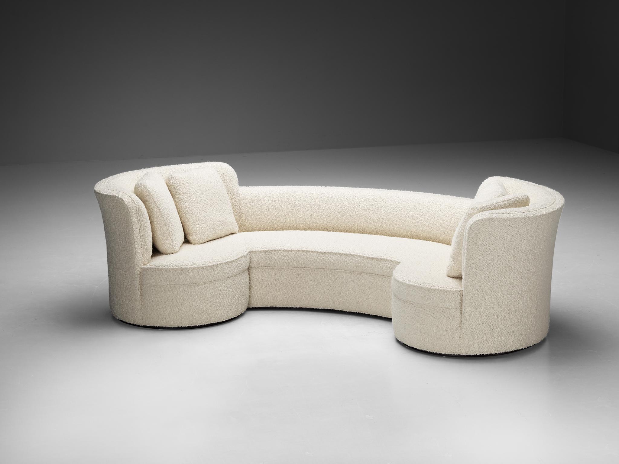 Edward Wormley for Dunbar, 'Oasis' sofa, model '5200', reupholstered in white boucle, wood, United States, 1952 

The 'Oasis' sofa (1952) is designed by Edward Wormley for Dunbar. The construction is defined by a crescent shape with round edges and
