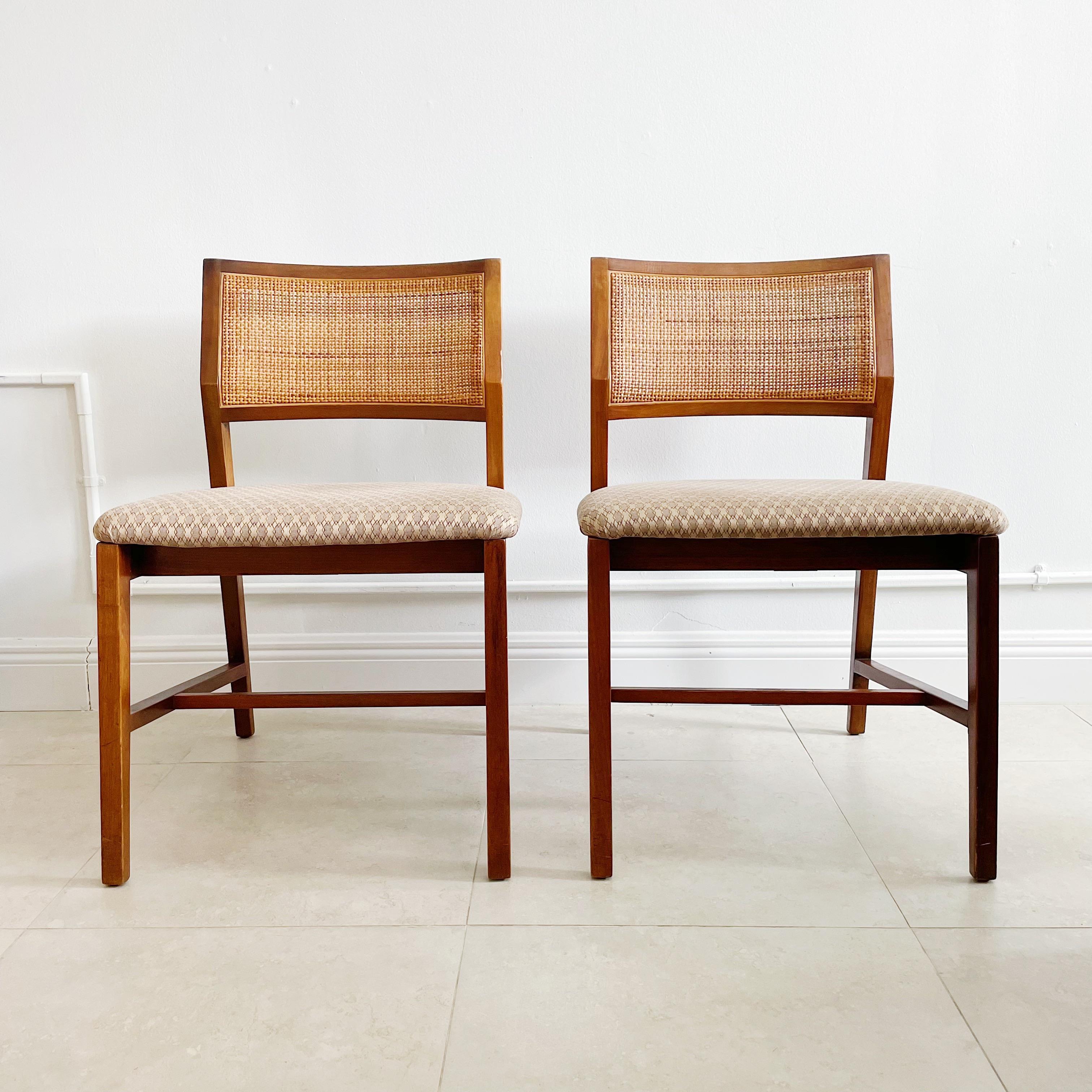 Exceptional pair of 1950's Edward Wormley for Dunbar walnut side chairs or game table chairs. They feature organic Vienna straw backs and original fabric seats. One pair available.