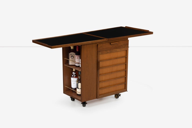 Edward Wormley for Dunbar Party server bar cart, Model 5433
Features one drawer and one door concealing two adjustable shelves along with one 27-inch fold down table top extension; table top measures 54