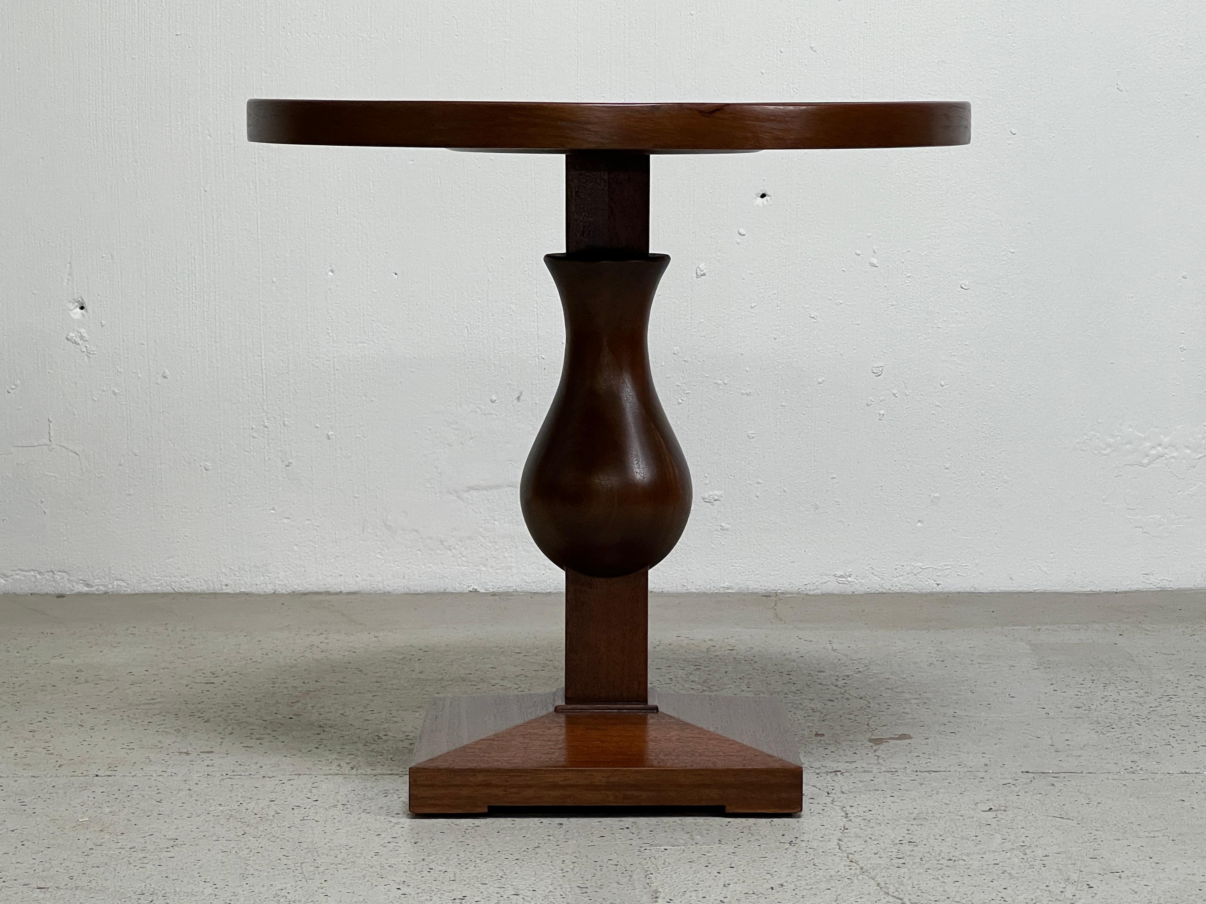 A mahogany pedestal table designed by Edward Wormley for Dunbar.
