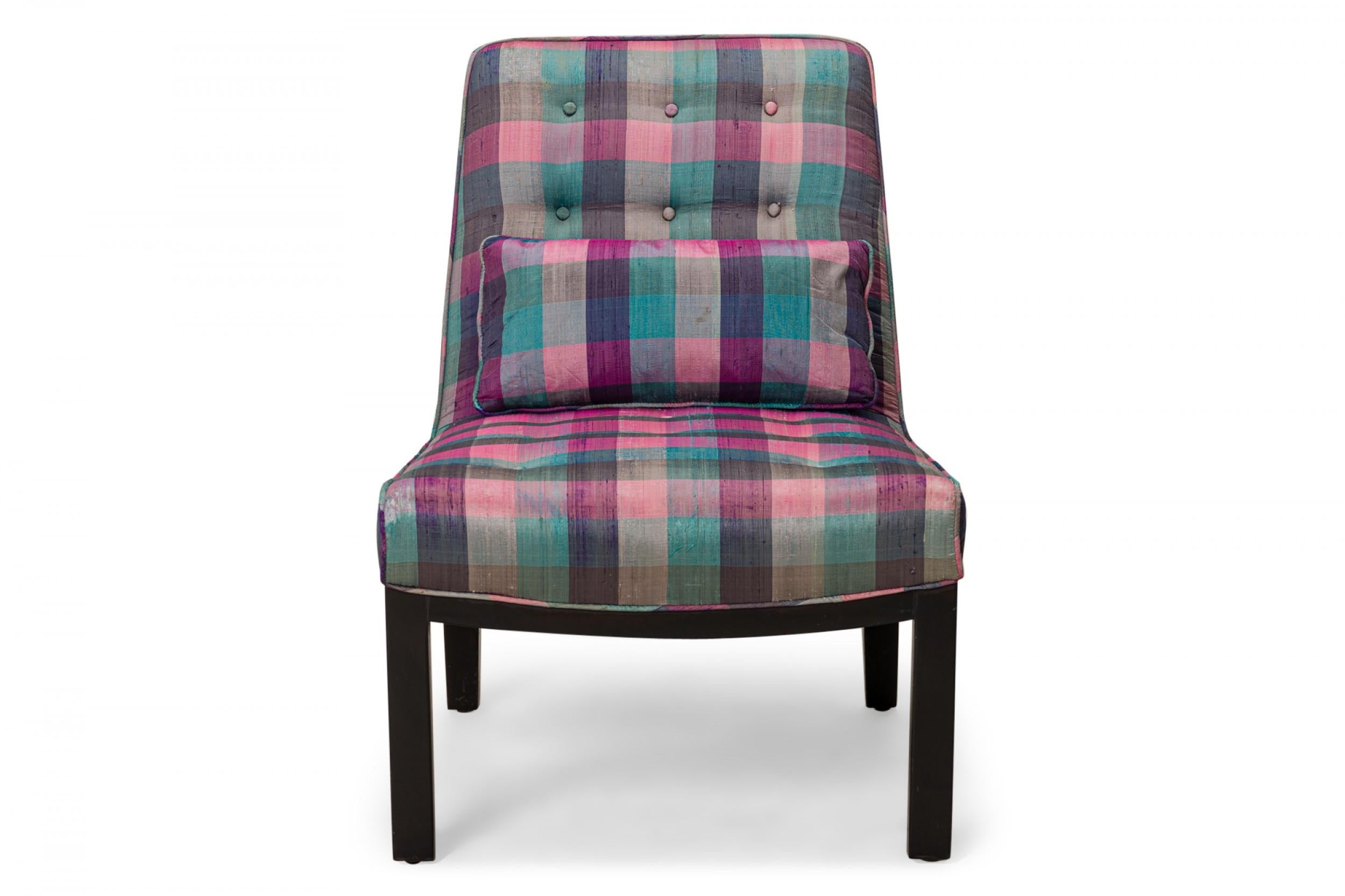 American Mid-Century slipper / side chair with purple, pink, and blue plaid fabric upholstery with button tufting and a matching rectangular throw pillow, resting on four square ebonized wooden legs. (EDWARD WORMLEY FOR DUNBAR FURNITURE COMPANY).