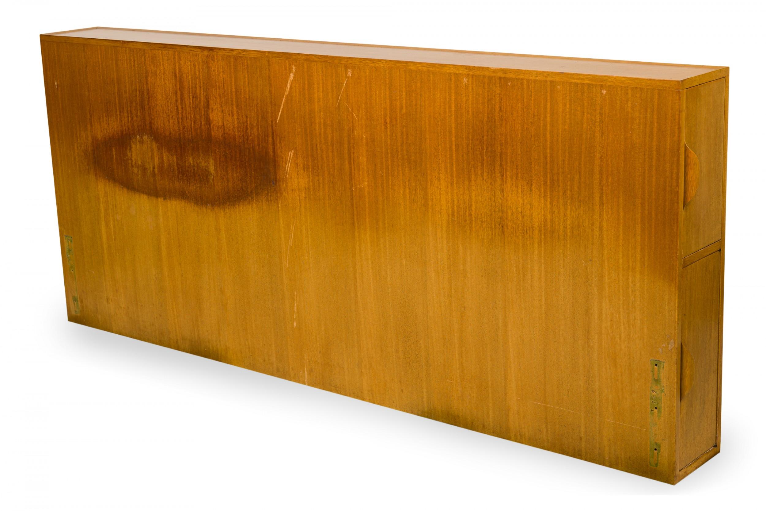 American Mid-Century wooden queen size storage headboard with two vertical drawers on either side with bentwood handles that open to reveal a lower open compartment and an upper compartment with a pivoting hinged interior shelf. (EDWARD WORMLEY FOR