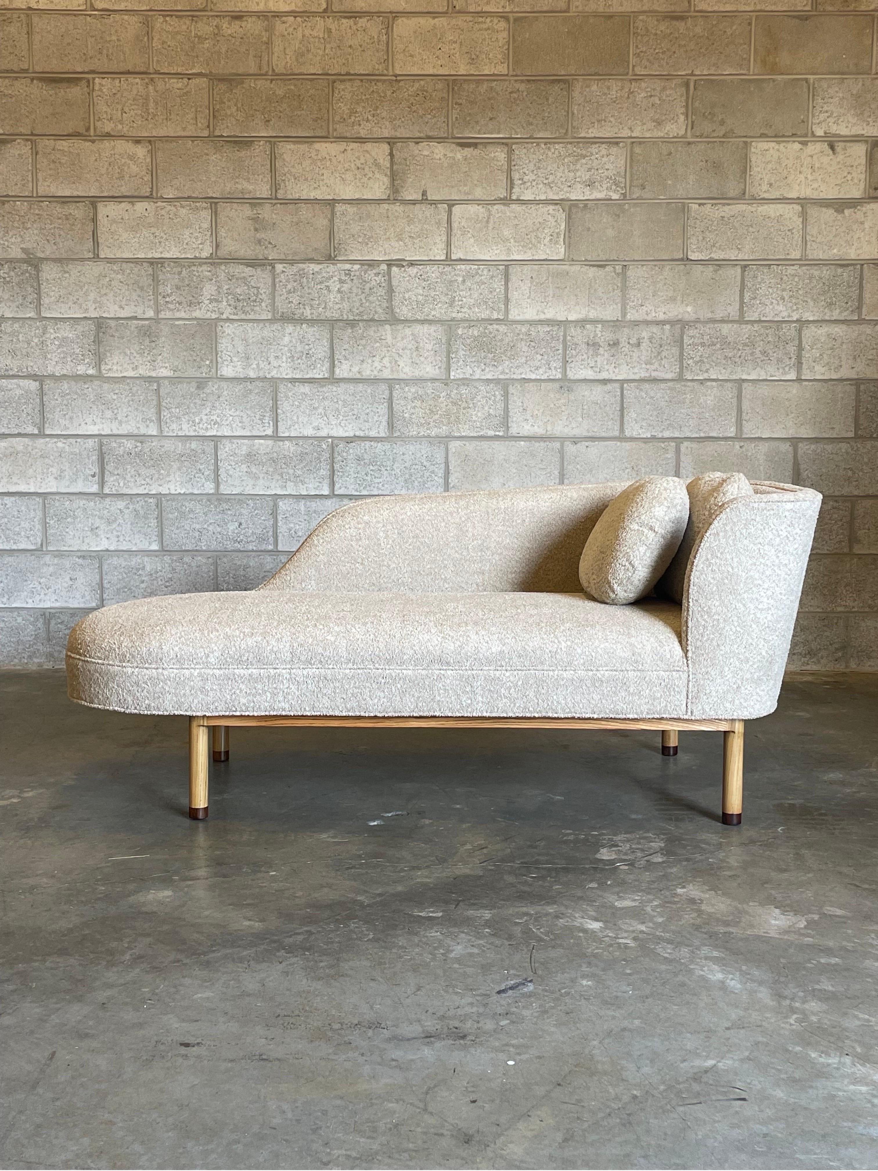 Edward Wormley for Dunbar chaise model 6750L. A beautiful and elegant chaise with a bleached/ natural colored ash frame complete with dark feet. Reupholstered in Robert Allen Camel/ Sand bouclé. Chaise is unmarked but is a documented