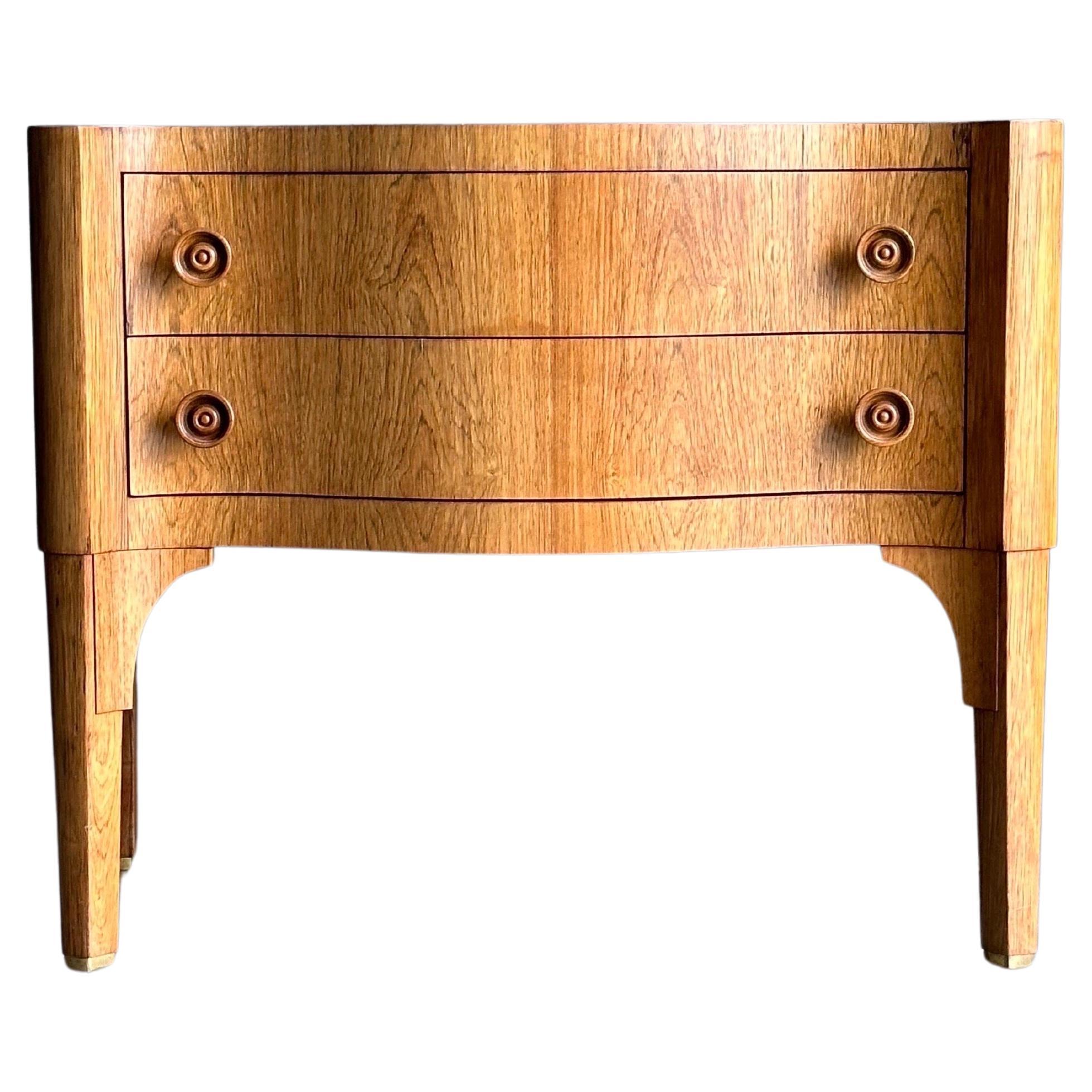 A rare small rosewood commode designed by Edward Wormley for Dunbar, model 6335A. Features a rosewood case with turned rosewood pulls. A very uncommon example, and especially so with this specific order being done in a custom height of 26”. Latch on
