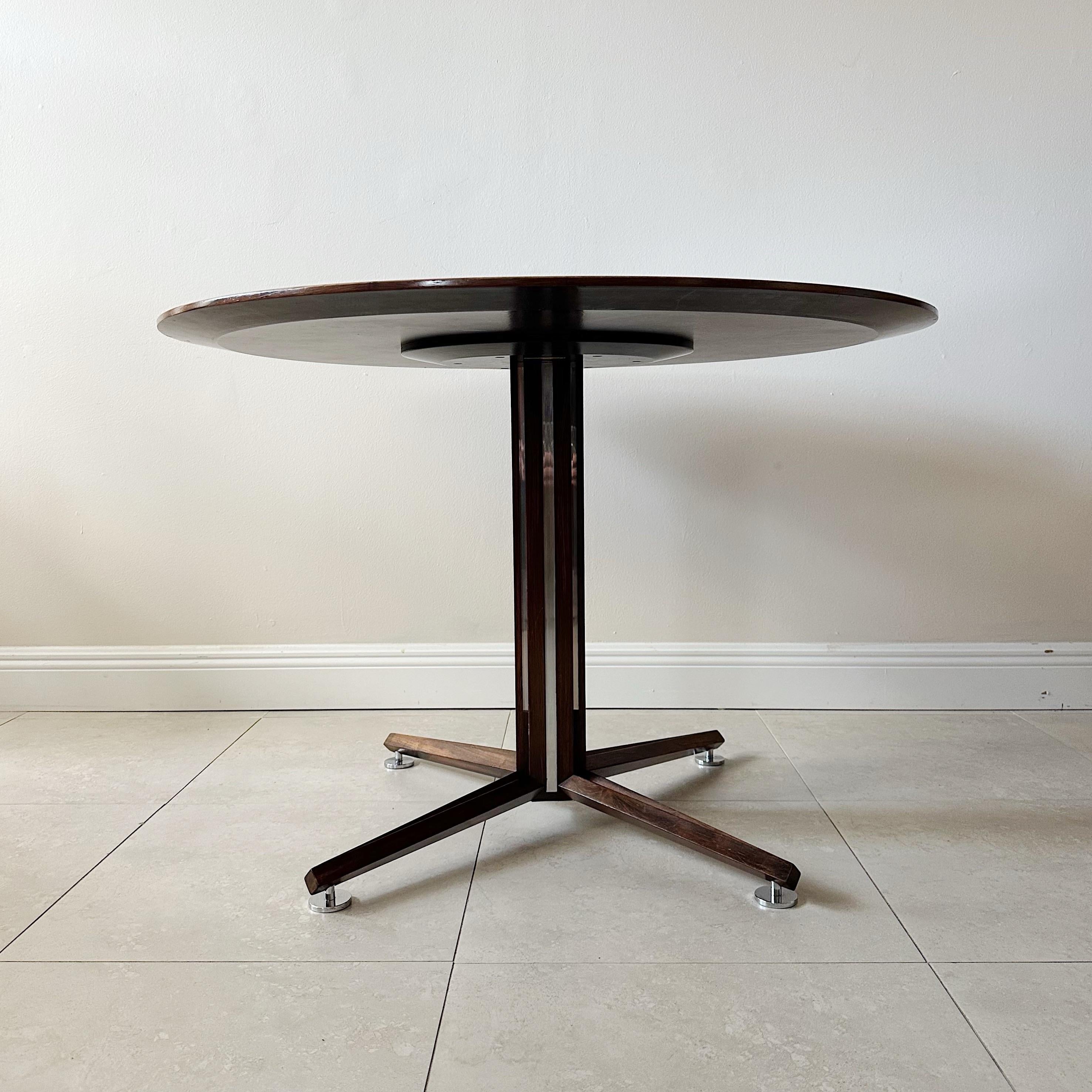Edward Wormley for Dunbar rosewood, chrome and black laminate top center round table from the 1960s. Strips of chrome are inset in the pedestal with chrome round pod feet. The top is a black laminate with minor surface wear light scratches from age