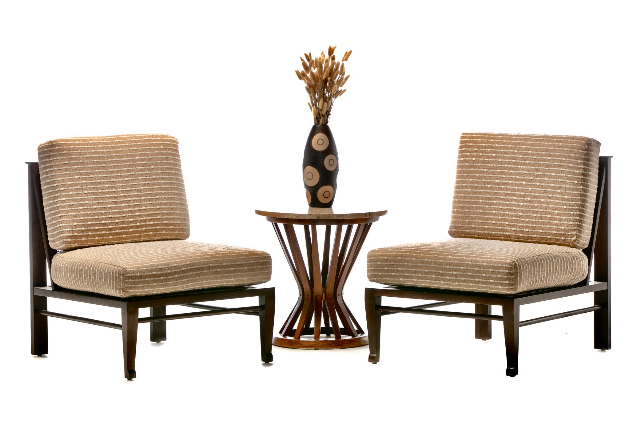 A well recognized walnut and travertine top side table made by Dunbar, this mid century modern table was designed by Edward Wormley and is referred to as Wormley's Sheaf of Wheat Table for its silhouette. Cinched at the waist, the walnut supports