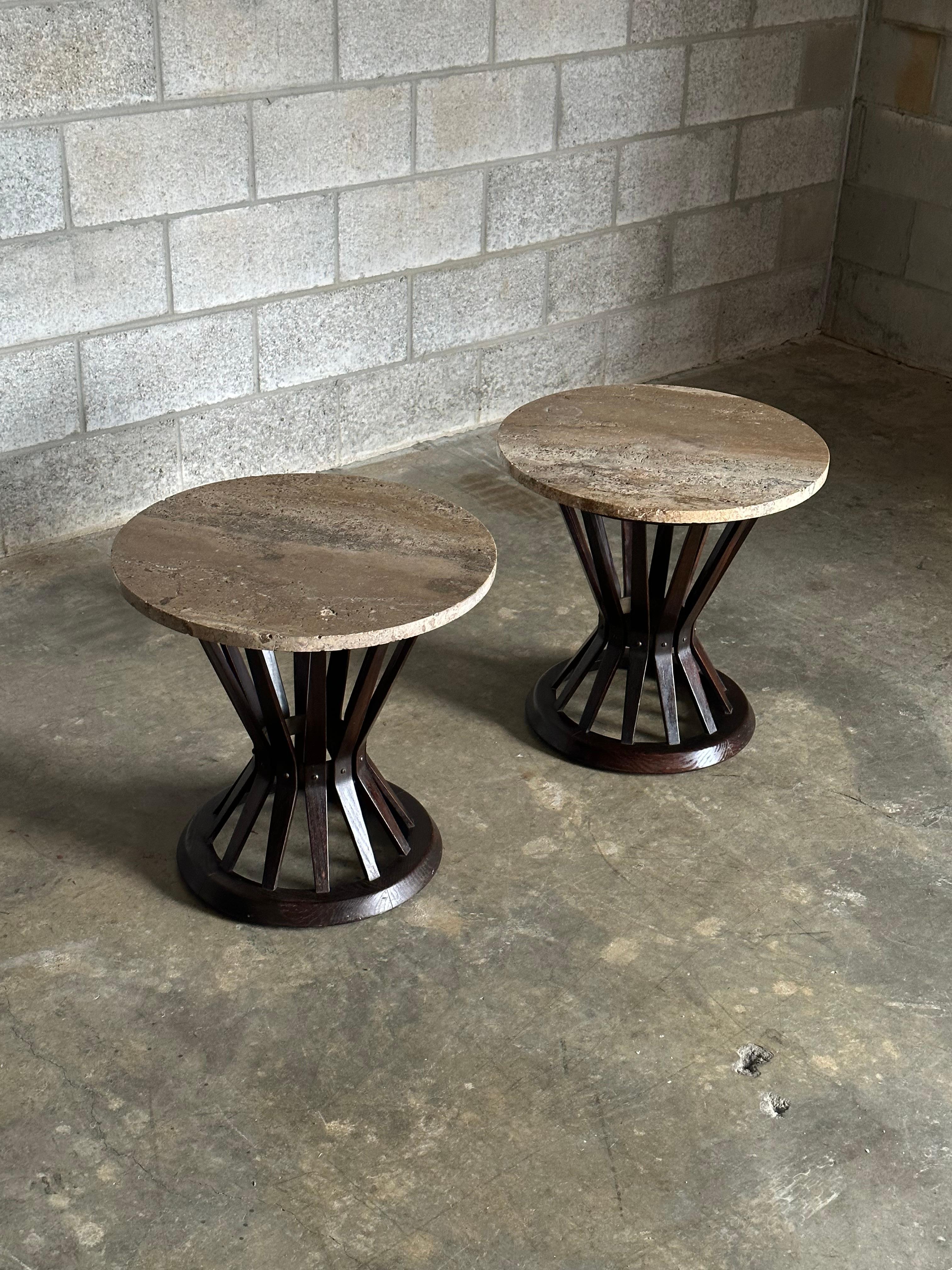 A rare pair of matching Edward Wormley Sheaf of Wheat Tables. Composed of an ash body with brass ring, they are complete with travertine tops. A timeless design with exciting use of materials, these tables could blend into basically any interior