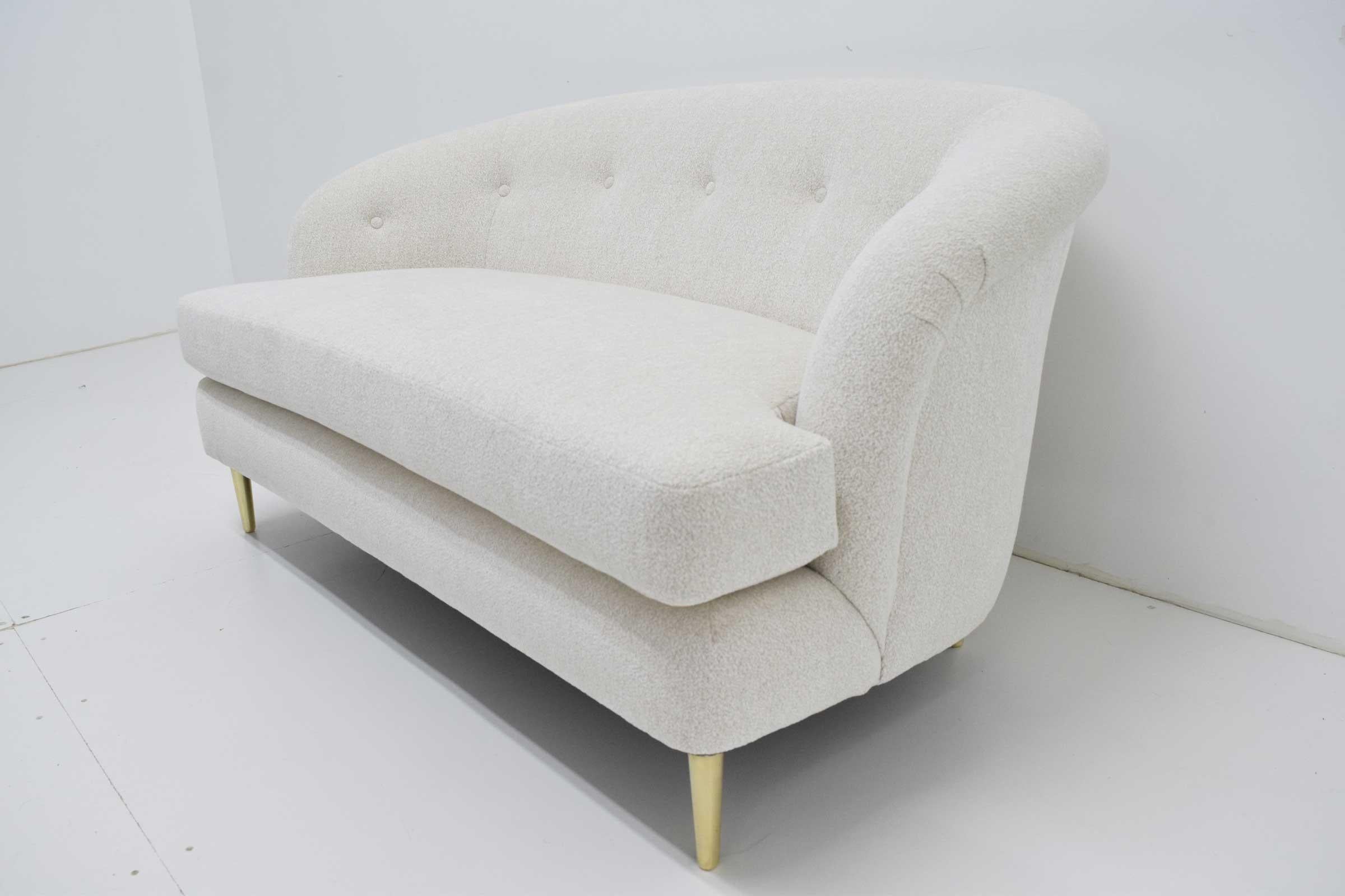 Beautifully restored Dunbar short sofa with brass legs. New upholstery by Larsen.