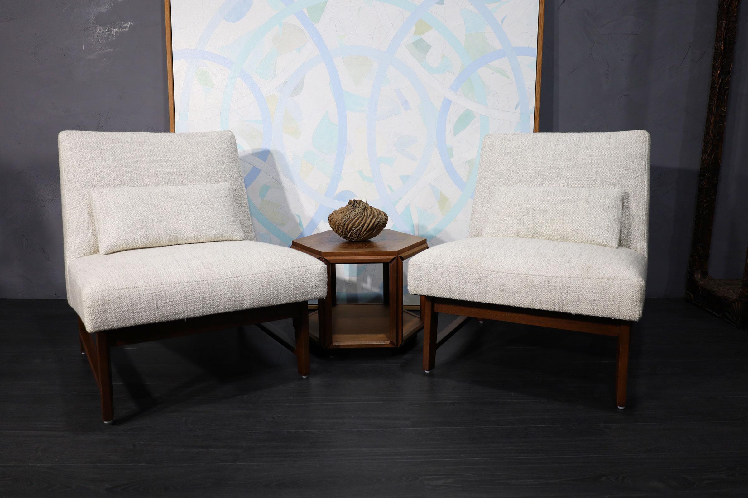 A pair of iconic slipper chairs by Edward Wormley for Dunbar. We have reupholstered these in a Holly HUnt Great Plains woven fabric of very high quality. Colors include mainly off-white.