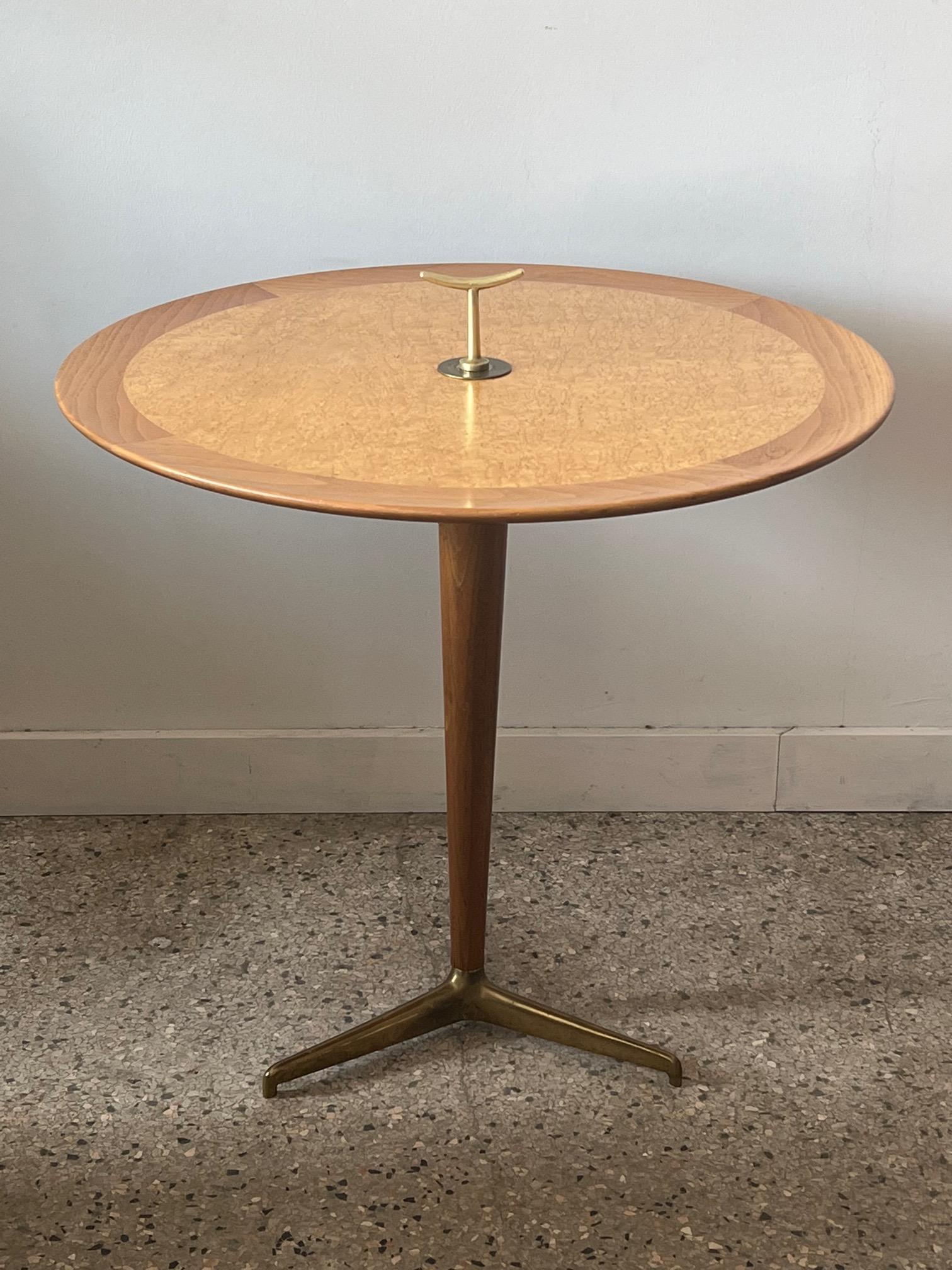 A classic and hard to find Edward Wormley for Dunbar snack table. Solid brass tripod base, Karelian birch top with typical finial.