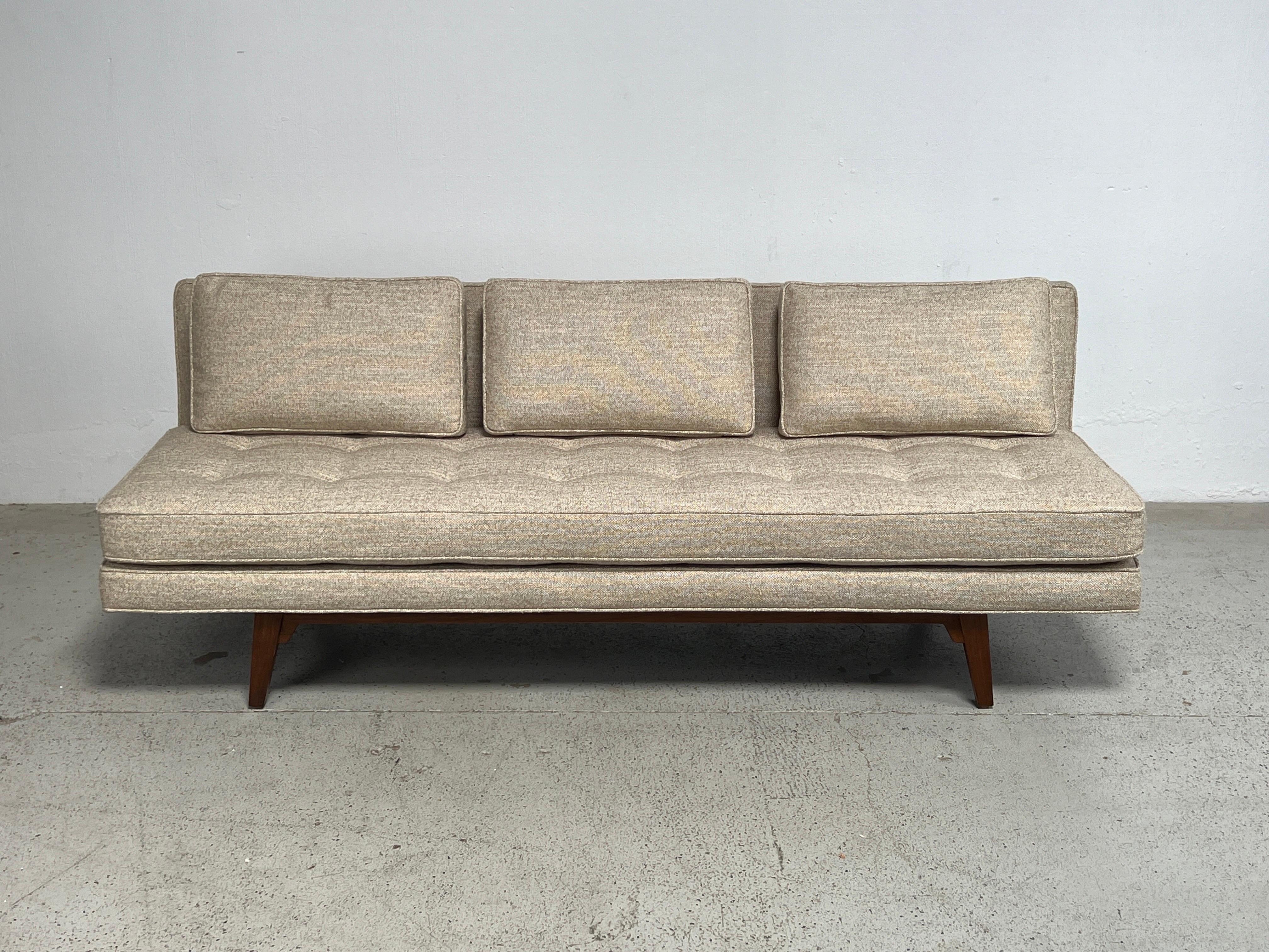 A walnut framed daybed / sofa designed by Edward Wormley for Dunbar. Fully restored and reupholstered in Holly Hunt fabric with new down back cushions. 