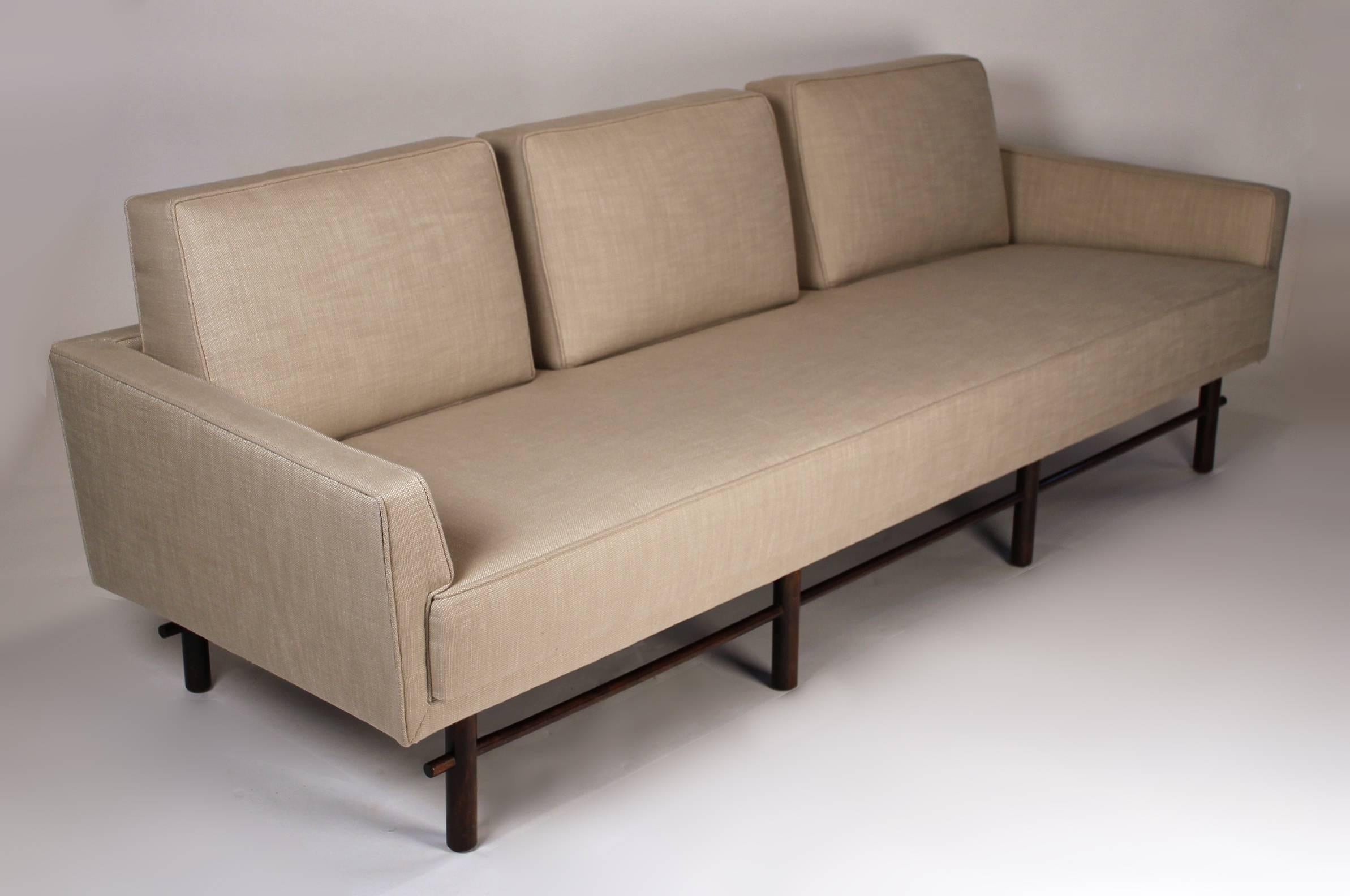 Early and scarcely seen three-seat sofa with fixed back cushions and flared tapering arms designed by Michael Taylor for Baker. A very comfortable sofa with incredibly clean lines. Reupholstered in a Perennial's tweed textile. All of the seat