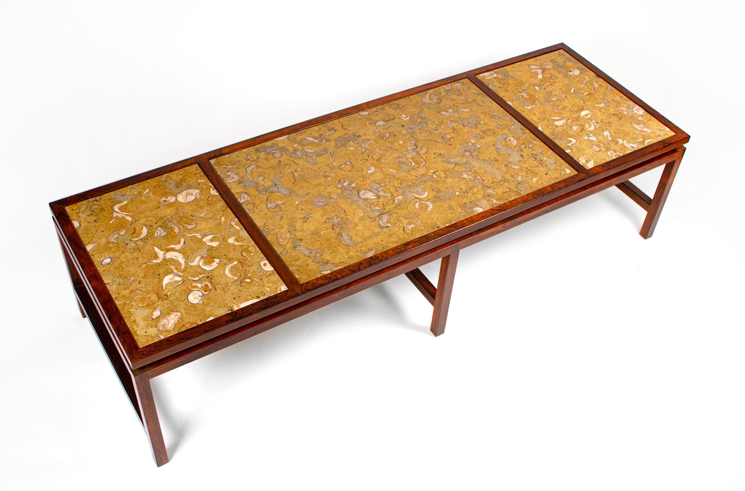 Solid Brazilian rosewood architectural coffee table with fossilized stone top designed by Edward Wormley for Dunbar. 
Incredibly unique.