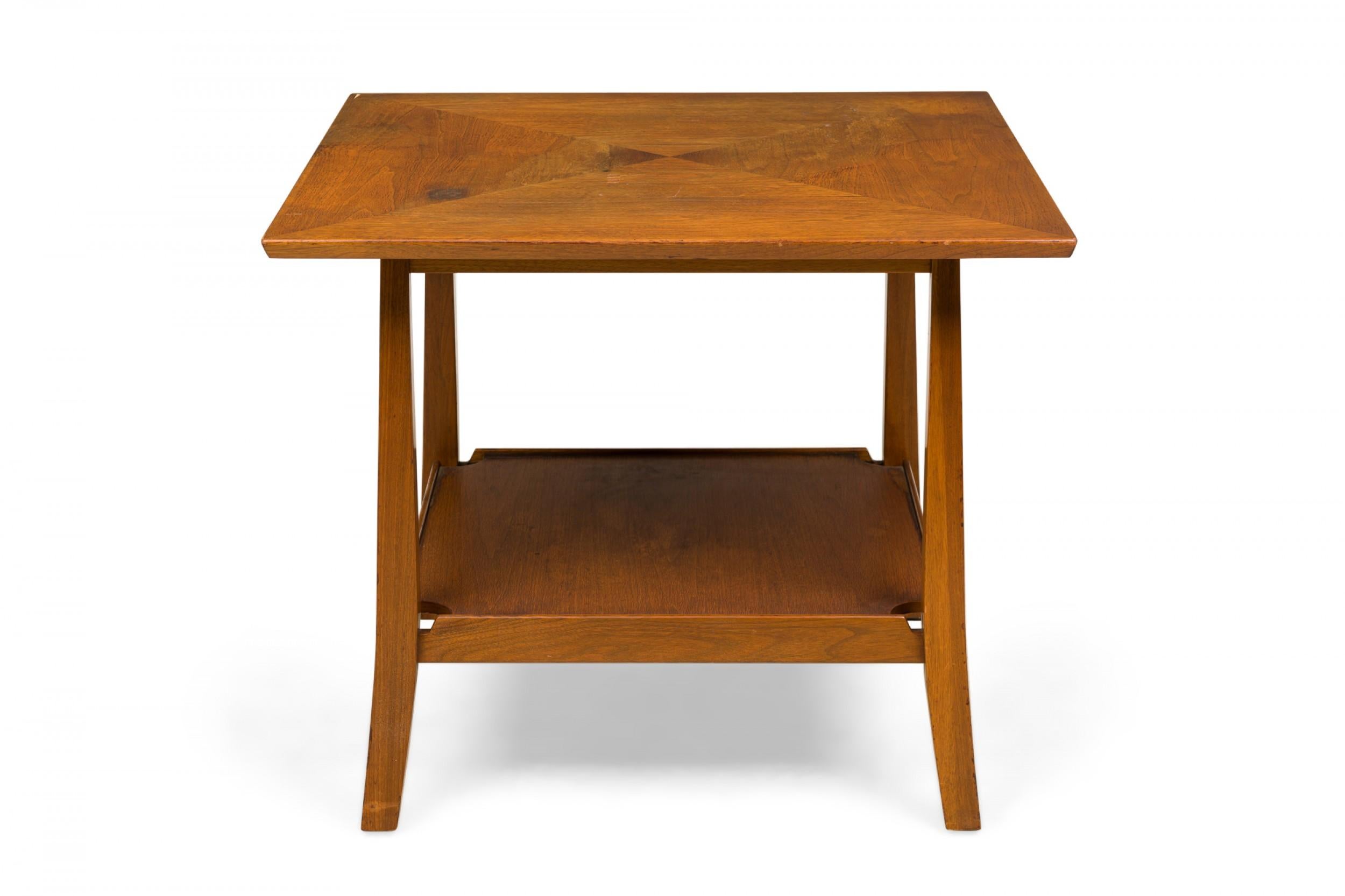 American Mid-Century wooden end / side table with a square top comprised of triangular panels that create a triangular grain pattern, resting on four square legs that curve slightly outward at the feet, connected by a square stretcher shelf. (EDWARD