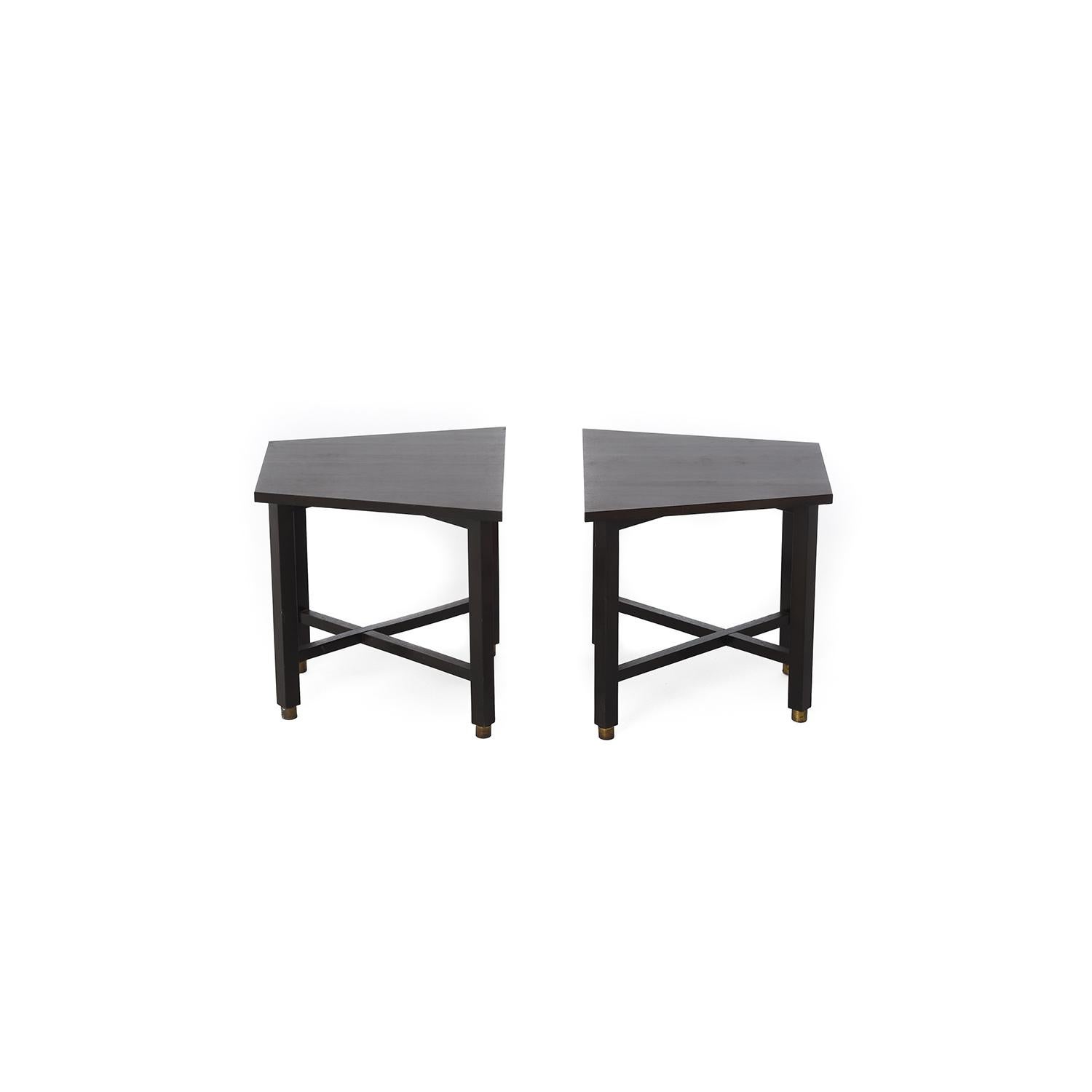 This snappy set of end tables by Edward Wormley are constructed with Formica tops in a dark faux wood grain. The leg bases are black heavyweight wood with brushed brass tone ferrules at the feet. 

Professional, skilled furniture restoration is an