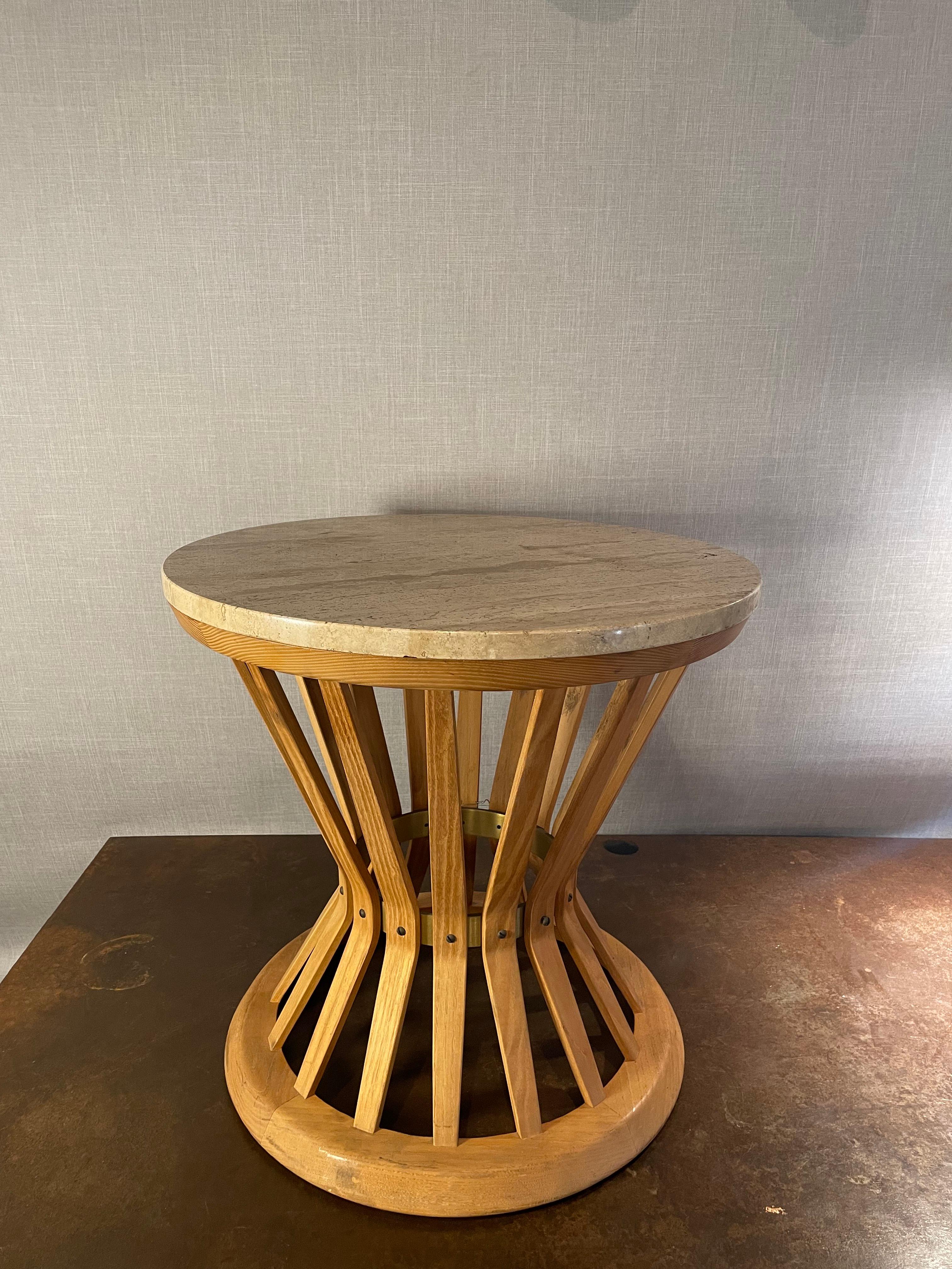An exceptional “Sheaf of Wheat” side table attributed to Edward Wormley for Dunbar, showcasing the sculptural harmony and refined craftsmanship that defined mid-century American design. The table features a beautifully honed travertine top, resting