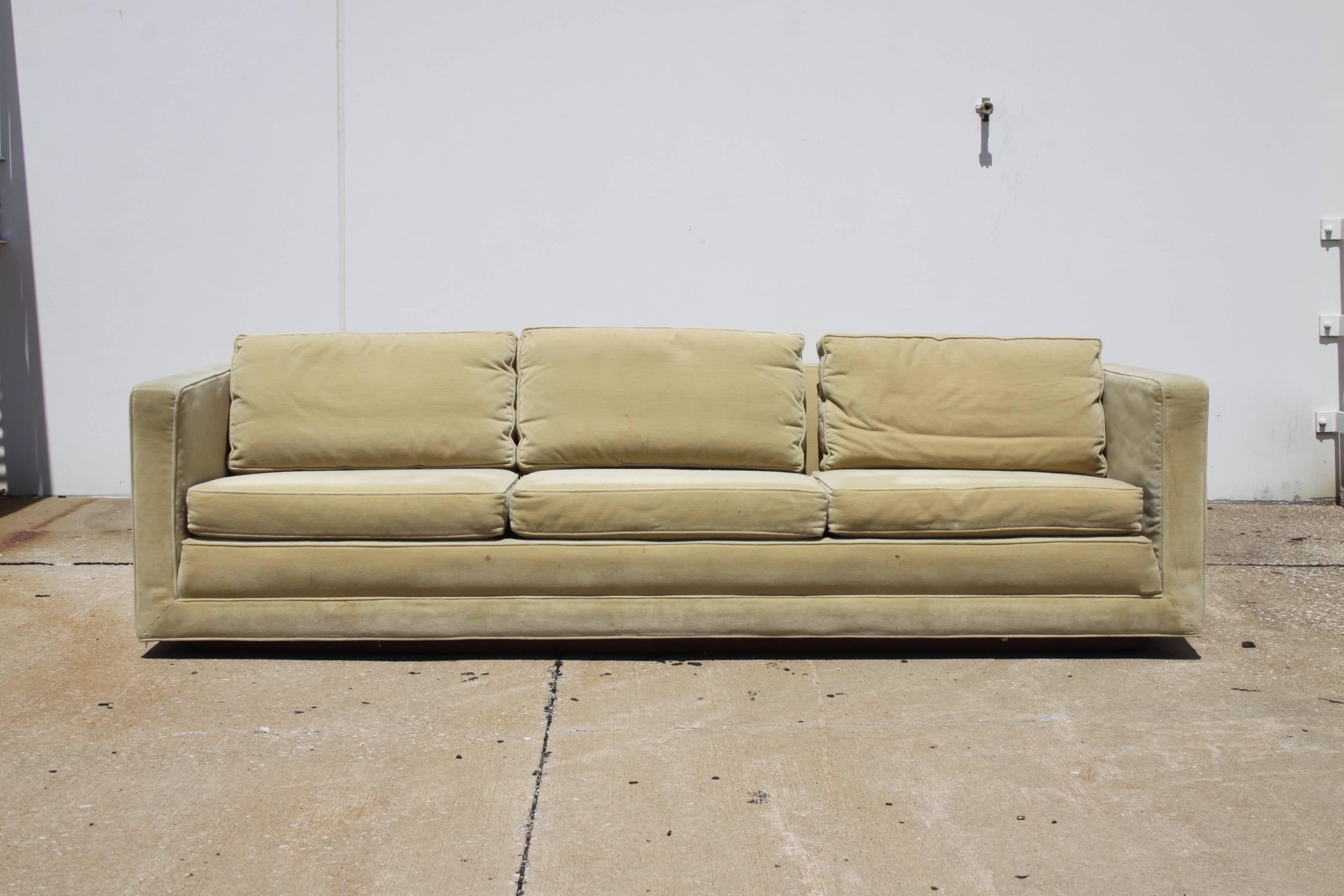 Elegant Edward Wormley for Dunbar Tuxedo sofa on recessed plinth base. This well built sofa, retains it original velvet upholstery, down back cushions and new seat foam on a walnut inset base. Upholstery needs to be updated as it shows stains to