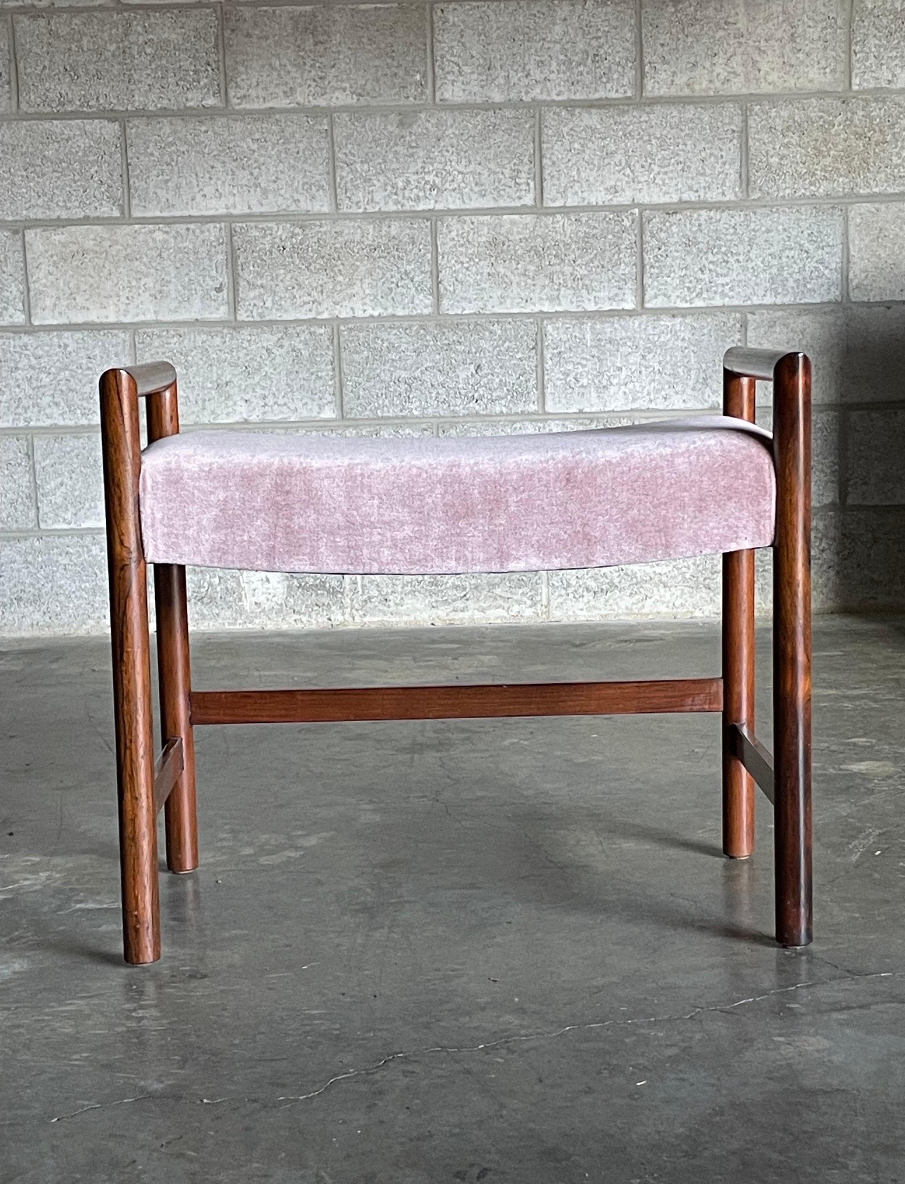An elegant vanity bench designed by Edward Wormley for Dunbar. Executed in a rosewood frame with new blush/ pink mohair upholstery. Very practical piece of furniture.

Other notable designers from the period include Harvey Probber, Tommi