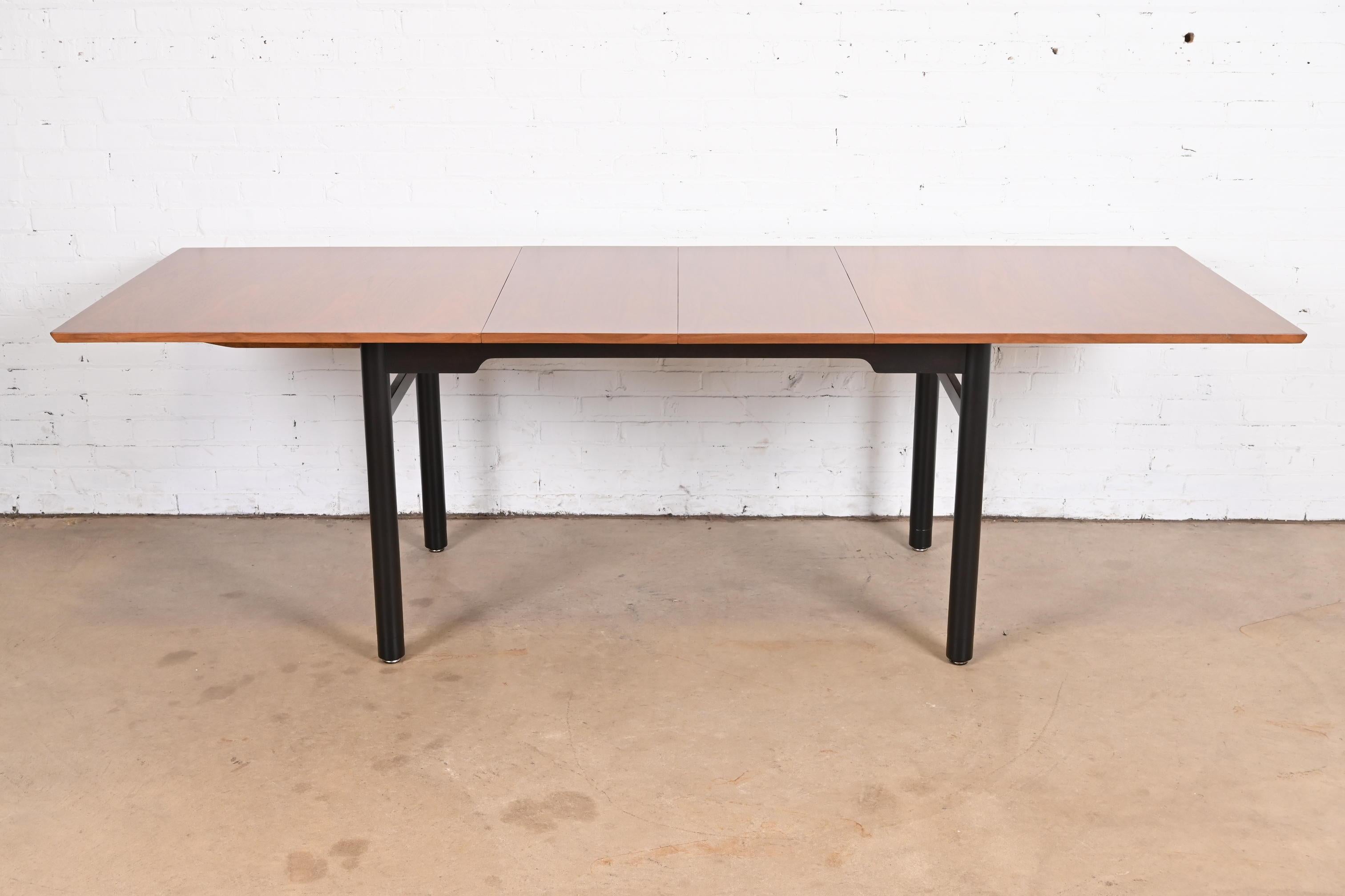 An exceptional Mid-Century Modern extension dining table

By Edward Wormley for Dunbar Furniture

USA, 1950s

Gorgeous bookmatched walnut top, with ebonized walnut legs and stretchers.

Measures: 66